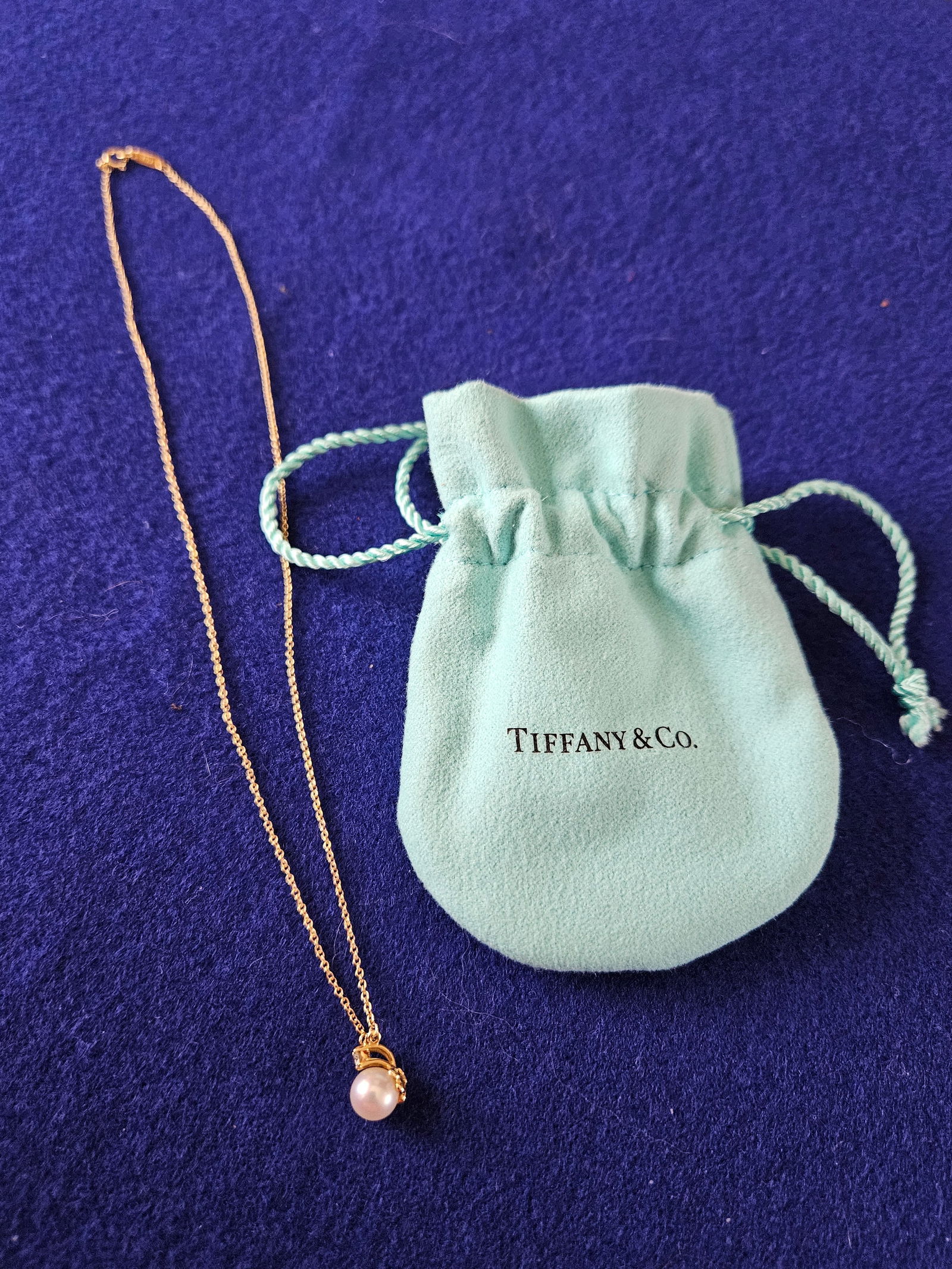 18K Gold Tiffany & Co Pearl and Diamond Necklace: 18K Yellow Gold Tiffany & Co Pearl and Diamond Necklace 16". It is in excellent condition with pouch.