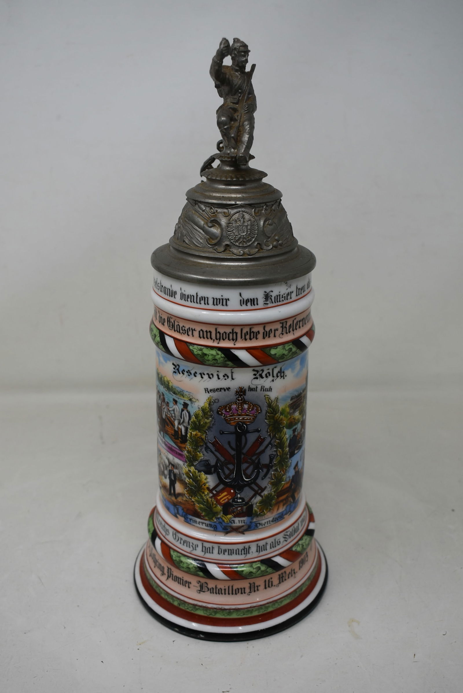 1/2 Liter German Regimental Porcelain Beer Stein 1903-05 Naval: German Regimental Beer Stein 1903/05, Naval Ship Scenes. Has roster on back side. Soldier Finial with Anchor Thumb Lift. Stein has great color. Very good condition.