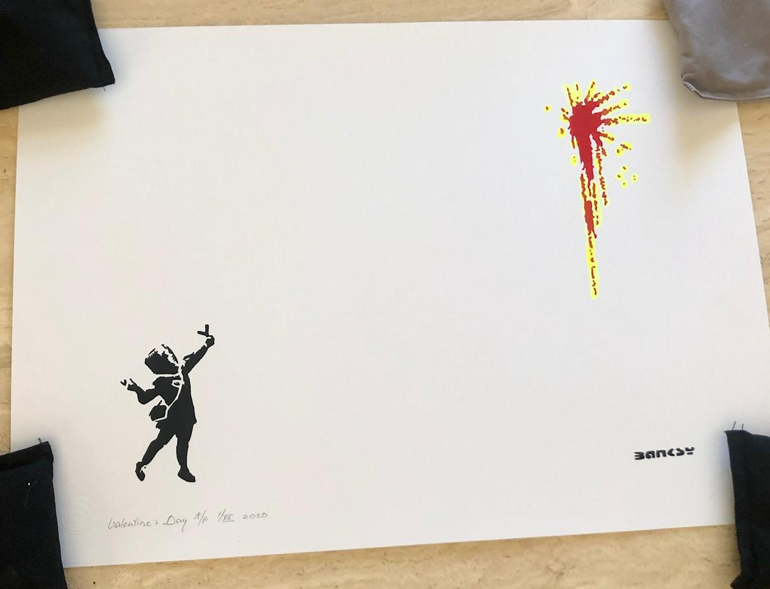 Banksy (After) - "Valentine's Day": (After) Banksy (b. 1973, England) "Valentine's Day” (2020) This work of art is a reproduction of the elusive artist's street art/stencil painting of a young girl with a slingshot sending red flowers