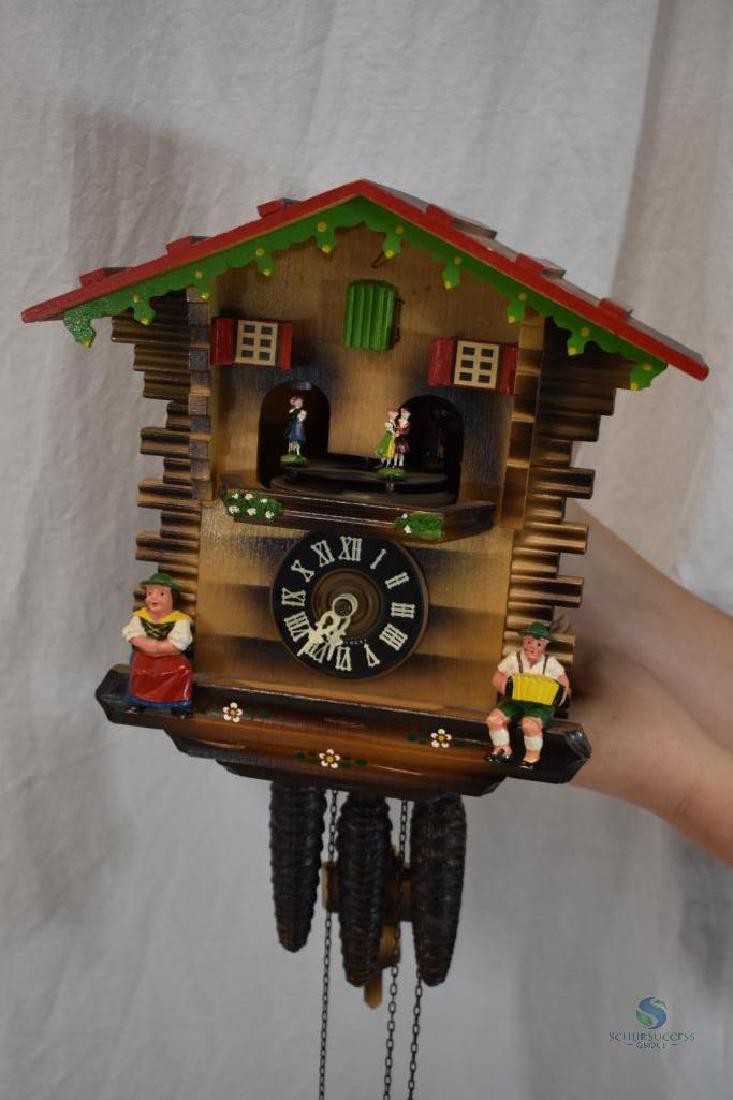 Cuckoo clock with 4 painted, dancing and rotating