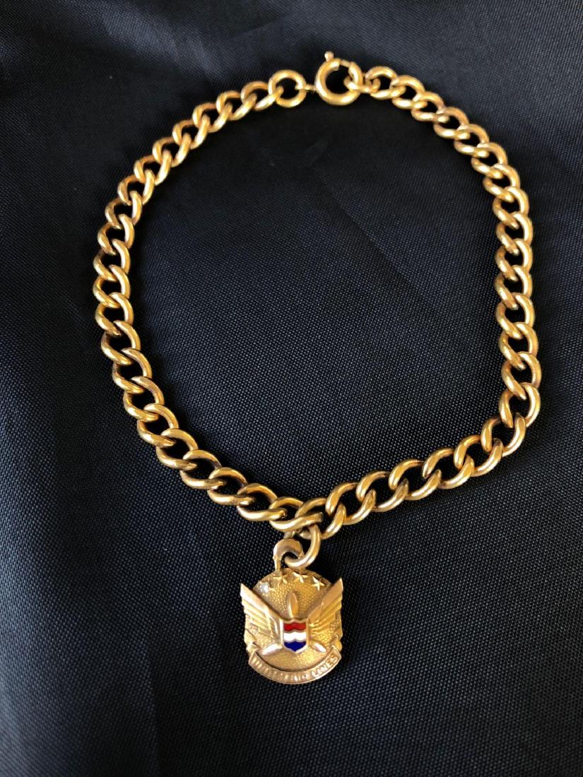 United Airlines 10K Gold and Diamond Employee Service B: United airlines employee service bracelet made of 10K gold and single diamond. 8.9g Total Weight including chain. Chain is marked 1/20 12KGF.