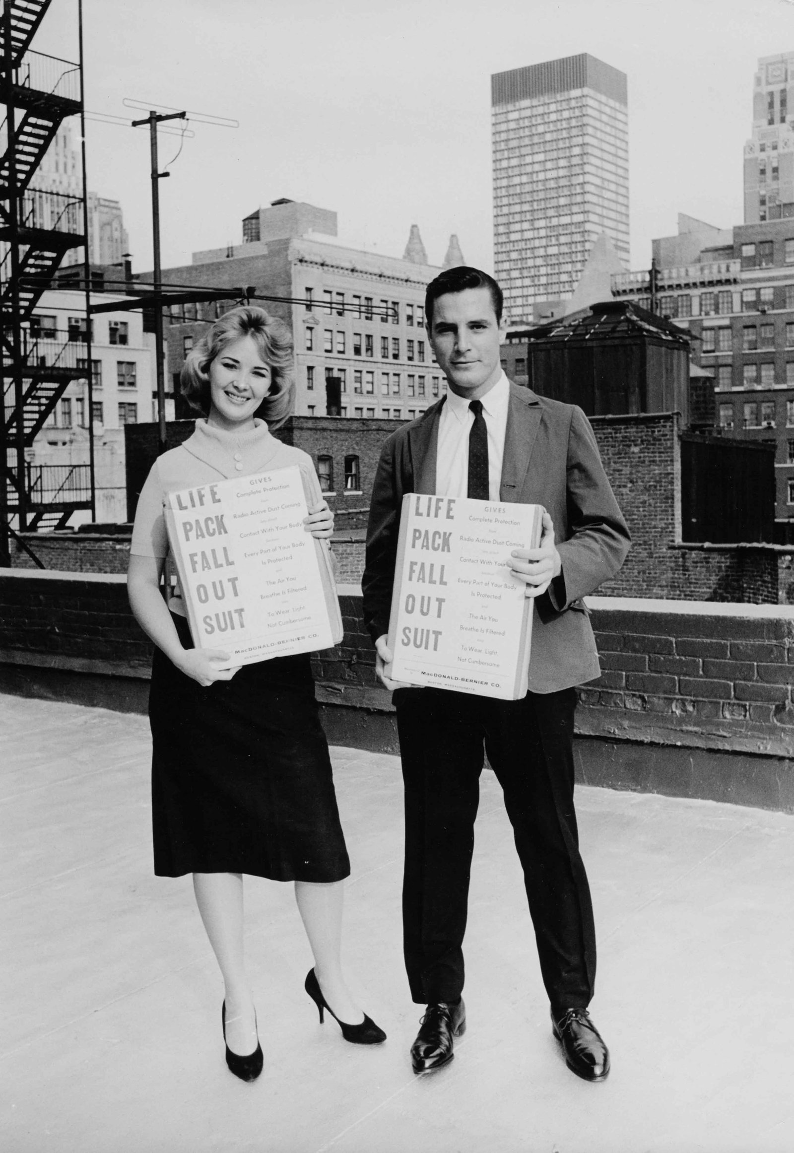 MAX SCHELER | Nuclear protection hysteria USA, c.1962: Vintage print, stamped, 30 x 21 cm Stern Emergency Life Pack for Nuclear Fallout, New York. At the height of Cold War civil-defence anxiety, Scheler photographed protective anti-fallout suits and surv