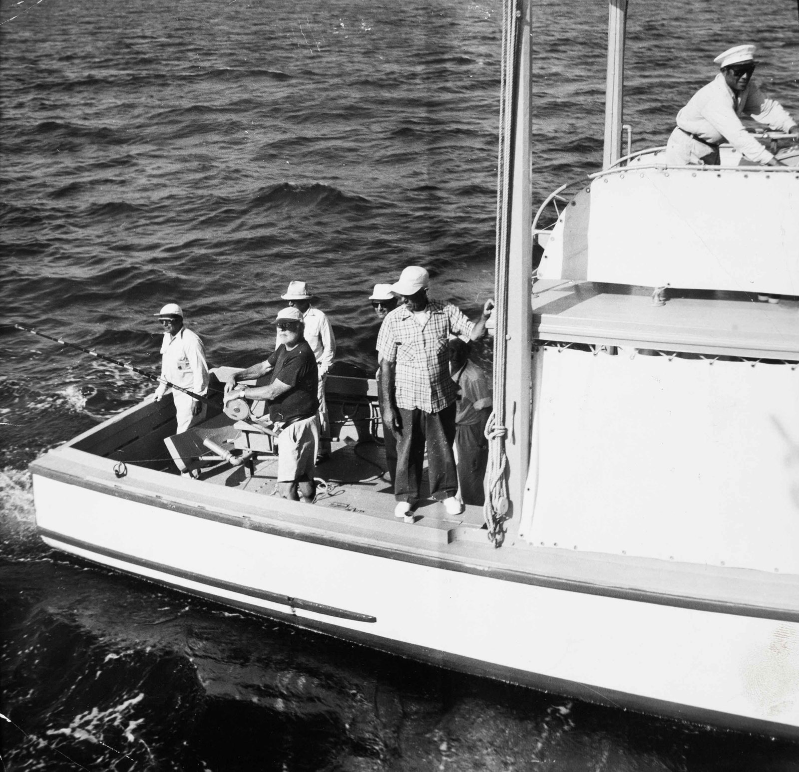 Ernest Hemingway, Big-game fishing , 1956: Vintage print, stamped, 21 x 21 cm La Prensa Ernest Hemingway is seen aboard the Miss Texas during a fishing expedition off Cuba. The original French press caption notes that Hemingway, ?hairy as a se