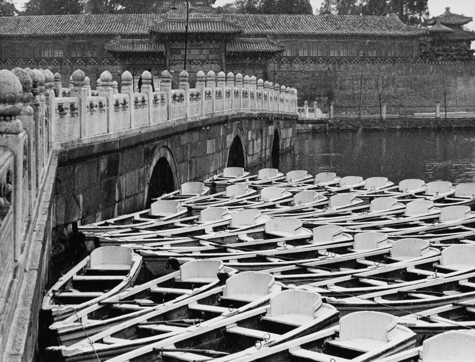 FERNAND GIGON | Beijing, China , 1956: Vintage print, stamped, 18 x 24 cm Aldo Palazzi Rowing boats moored beside a white stone bridge in Beihai Park. The bridge and the imperial-style buildings in the background belong to one of the histo