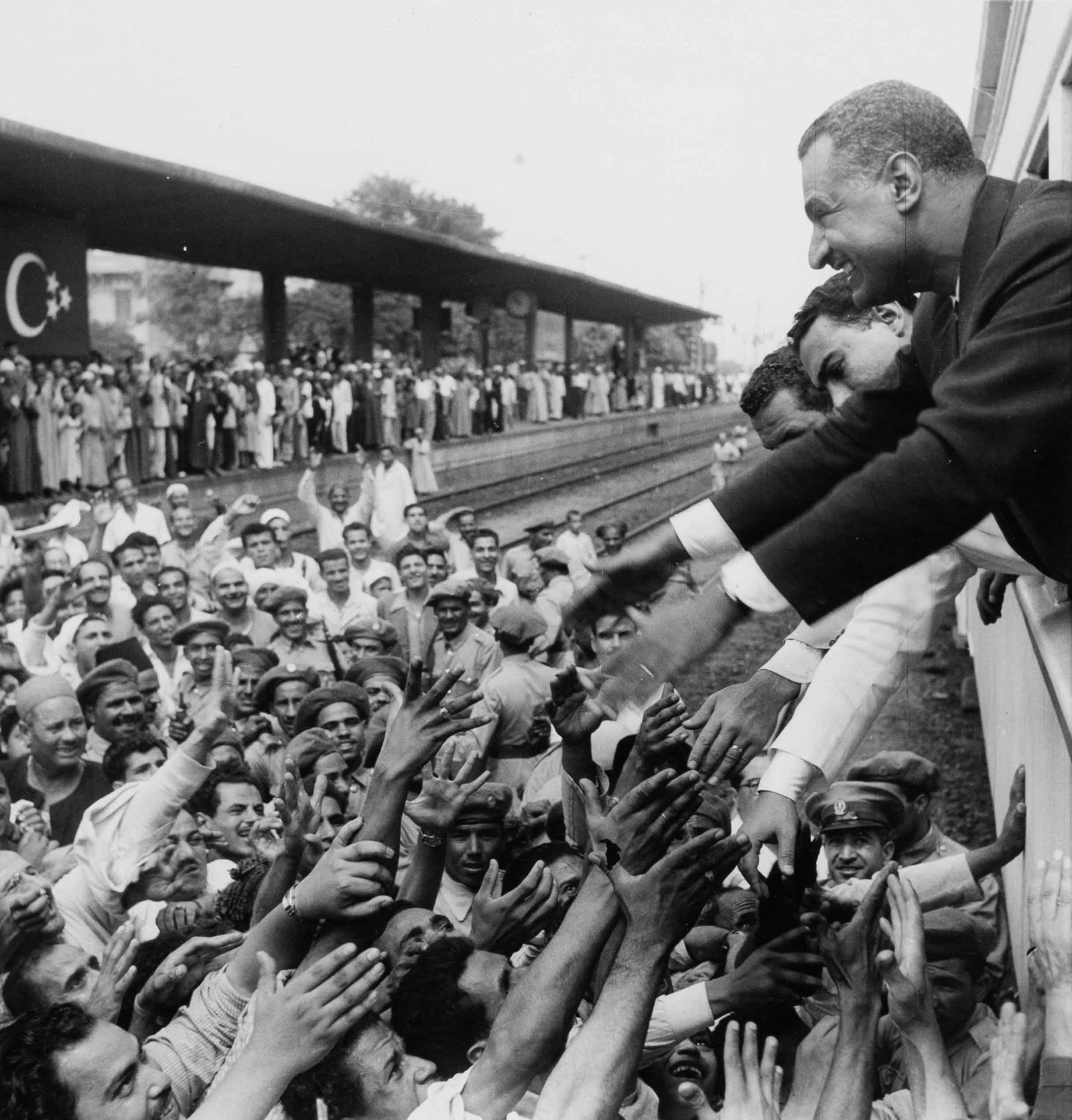 A. MASRAFF | Gamal Abdel Nasser , 1956: Vintage print, stamped, 24 x 18 cm Al-Ahram(Journal)In July 1956, shortly after announcing the nationalisation of the Suez Canal in Alexandria, Gamal Abdel Nasser returned to Cairo by train, stopping 