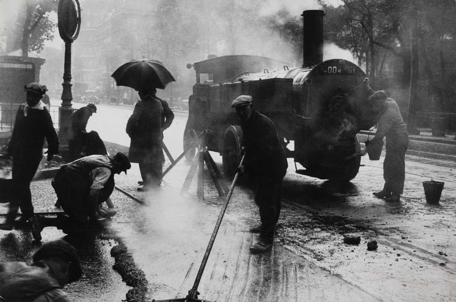 GISÈLE FREUND (1908–2000): GISÈLE FREUND (1908–2000) | Street repair, Paris 1933 Image Size: 19.1 x 28.6 cm English Vintage gelatin silver print, in good condition. Photographer's credit and copyright stamp, agency s