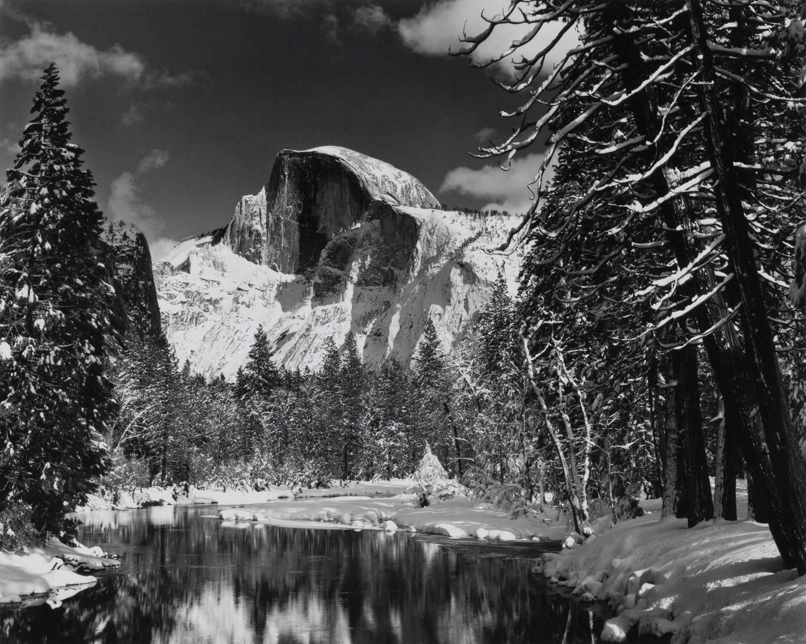 ANSEL ADAMS (1902–1984): ANSEL ADAMS (1902–1984) | Half Dome, Merced River, Winter, Yosemite National Park, California 1938 Image Size: 19 x 23.7 cm English Gelatin silver print, printed later by Alan Ross,