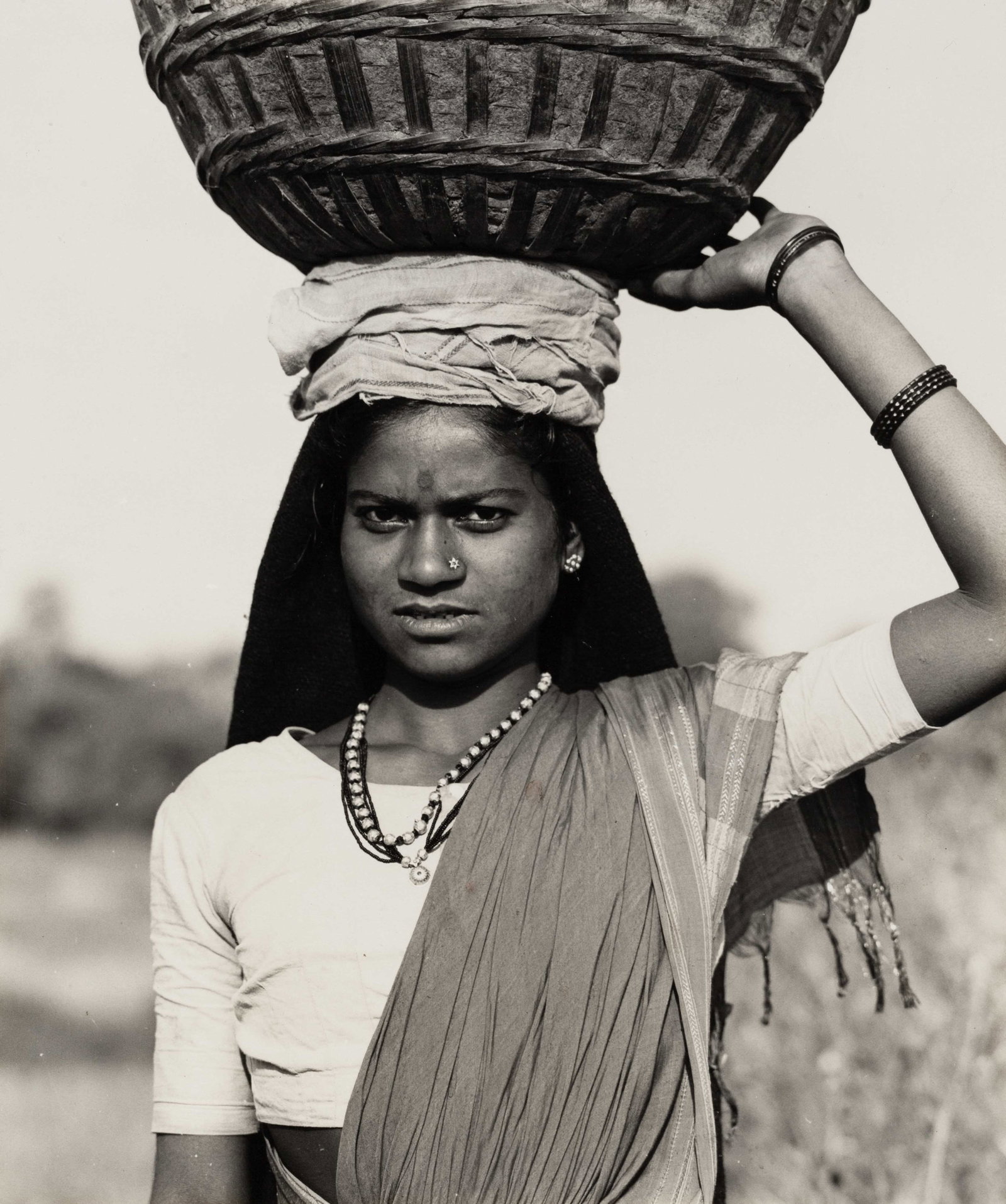 HENRI CARTIER-BRESSON (1908–2004): HENRI CARTIER-BRESSON (1908–2004) | Indian woman carrying a basket on her head, India 1950s Image Size: 27.6 x 23.2 cm English Gelatin silver print, printed in the 1970s, in very good