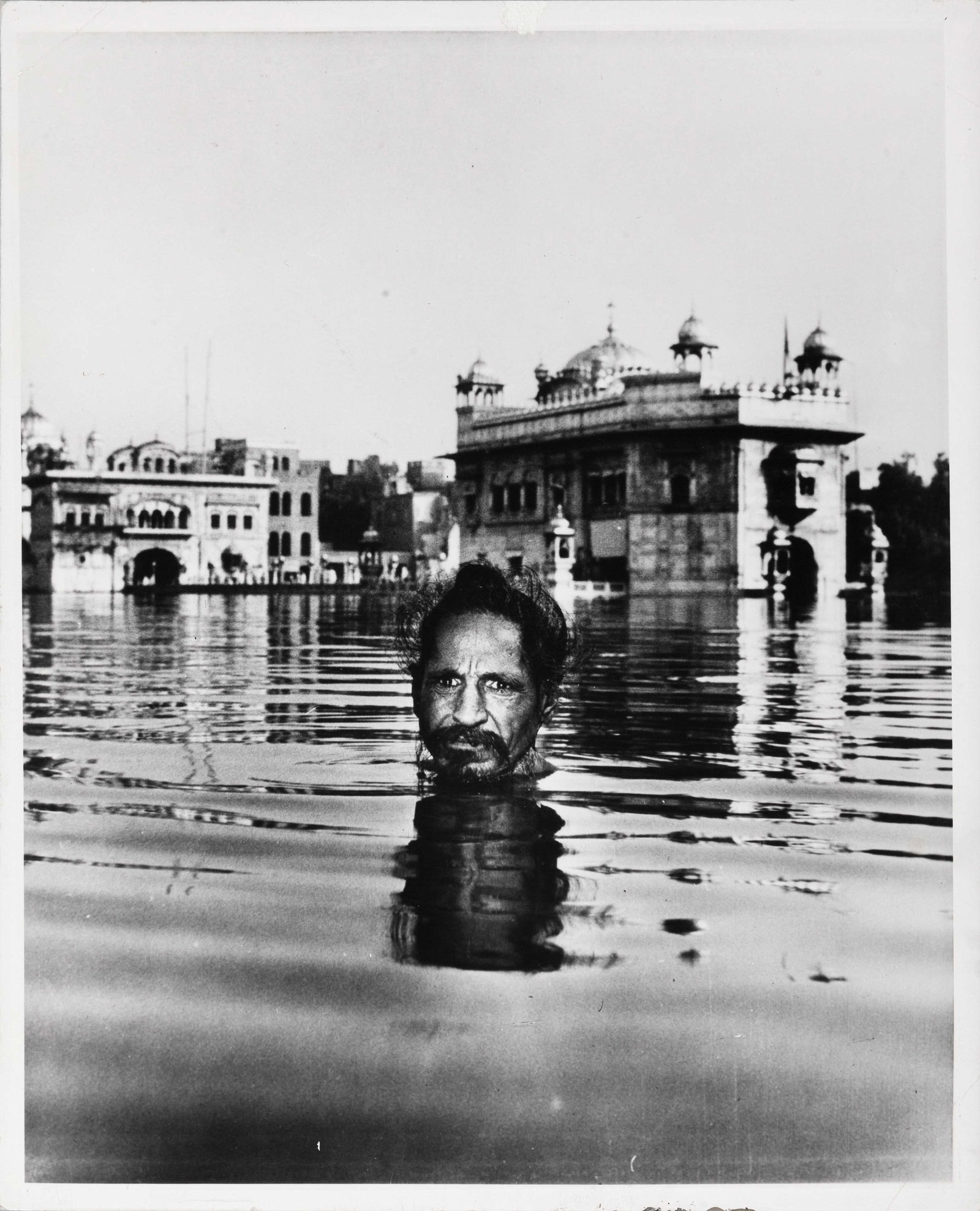 MARGARET BOURKE-WHITE (1904–1971): MARGARET BOURKE-WHITE (1904–1971) | Bathing Sikh, India 1946 Image Size: 24 x 19.3 cm English Gelatin silver print, printed later, 25.3 x 20.5 cm, in very good condition. "LIFE" credit stamp