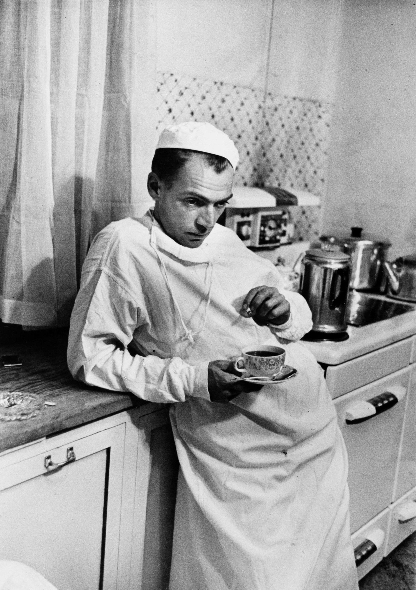 WILLIAM EUGENE SMITH (1918–1978): WILLIAM EUGENE SMITH (1918–1978) | Dr Ceriani in his kitchen after a night of operations, from the series 'Country Doctor' Colorado, Kremmling, 1948 Image Size: 24.1 x 17.1 cm English Gelatin
