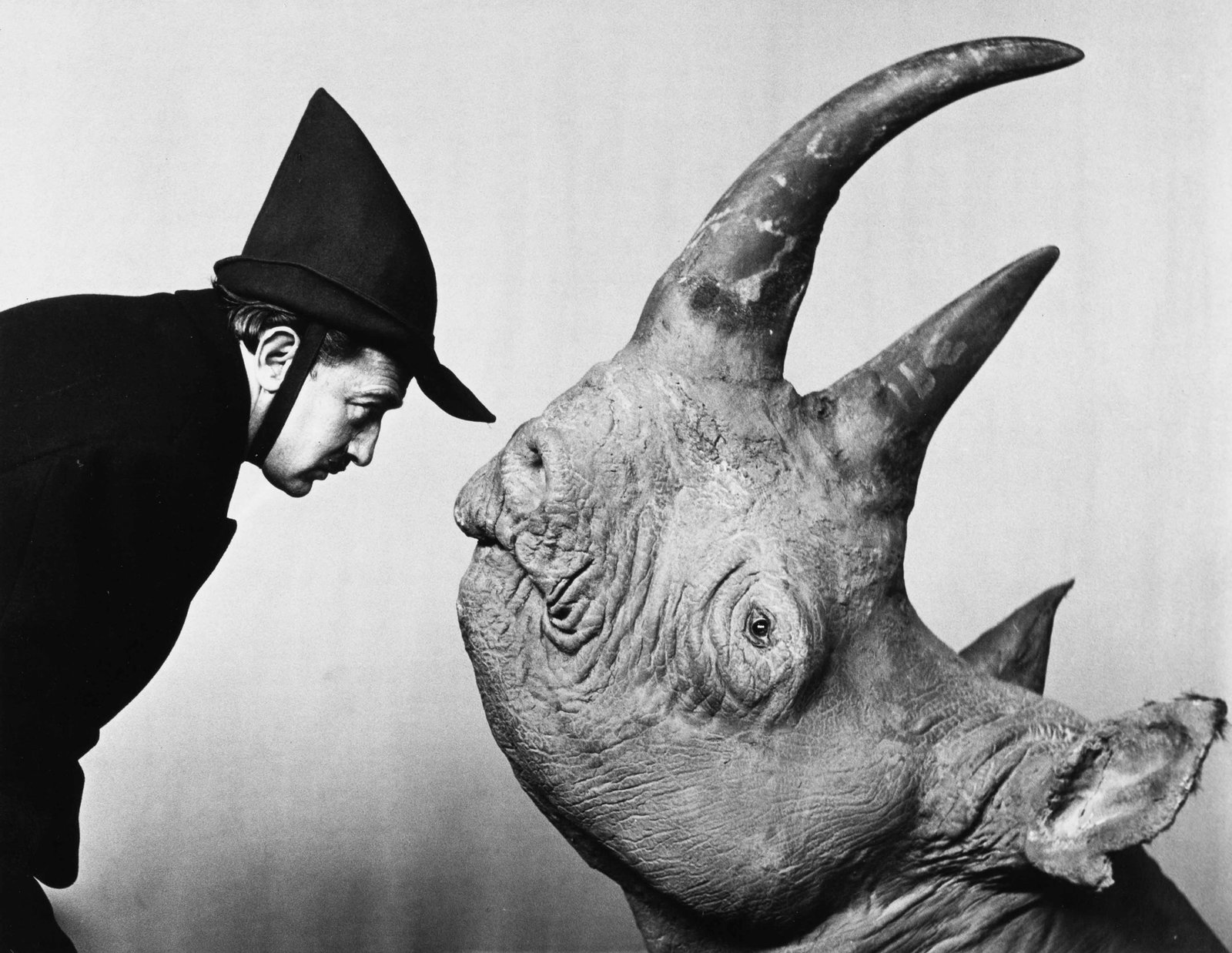 PHILIPPE HALSMAN (1906–1979): PHILIPPE HALSMAN (1906–1979) | 'Dalí with Rhinoceros', 1956 Image Size: 25.4 x 32.9 cm English Gelatin silver print, printed in 1981, 27.8 x 35.2 cm, in very good condition. Photographer's
