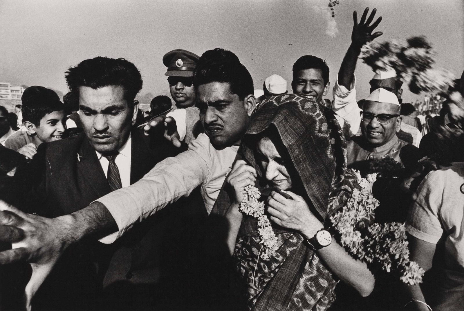 RAGHU RAI (1942–2026): RAGHU RAI (1942–2026) | Indira Gandhi is escorted by Sikh security forces, Delhi 1977 Image Size: 36.6 x 55 cm English Gelatin silver print, printed in 1989 on RC paper 60.5 x 50.7 cm, in good