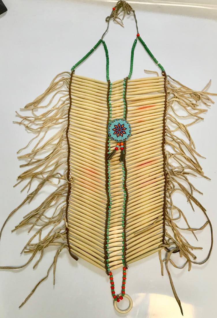 Native American Apache, Indian Bone Breast Plate: Native American Apache, Indian Bone Breast Plate Materials are bone hair pipe, crow beads, deerskin, padre beads, Preserved in this estate for decades is now available for sale Measures 36 x 11 inches