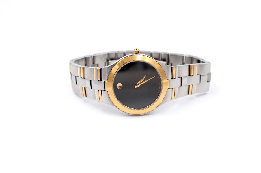 Movado Museum Two Tone Classic 36 mm Watch: Movado Museum Two Tone Classic 36 mm Watch Classic smooth gold tone bezel and deployment bracelet with all links present Quartz movement, Gold tone crown, 36 mm watch with black dial. GIA Gemologist i
