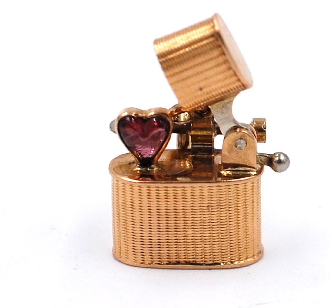 Rare Cigarette Heart Stone Charm, 14 karat Yellow Gold,: Rare Cigarette Heart Stone Charm, 14 karat Yellow Gold, Movable Parts, 1 inch Rare, Circa 1935: Measures 1/2 inch in long. 14 karat 2.7 grams of gold. Movable part opens up to inside heart shaped red 