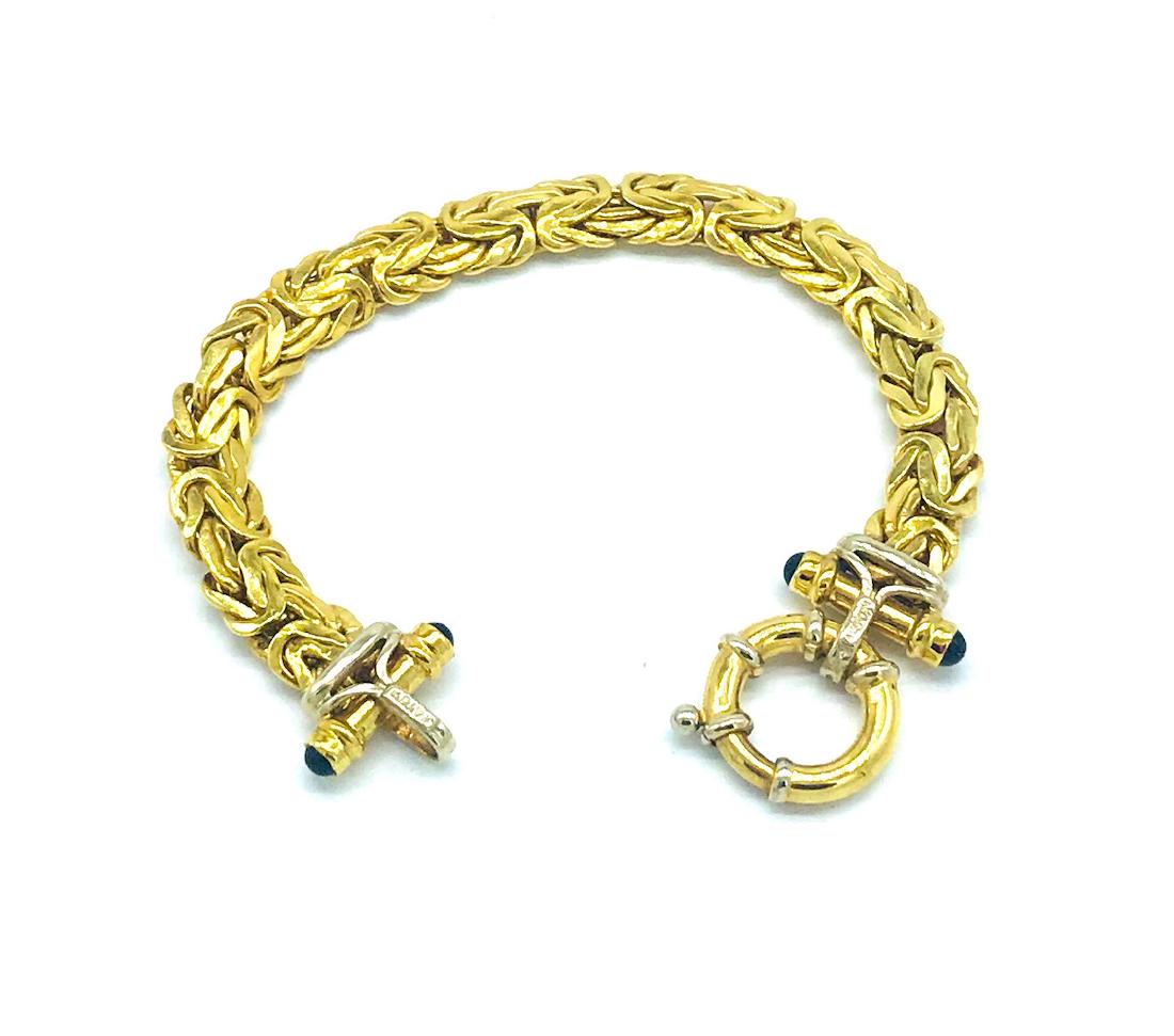 Byzantine, Sapphire .60 CT Cabochon, 14 Kt Bracelet: Byzantine, Sapphire Cabochon, 14 Kt Bracelet 20.8 grams of gold and 7 inches in length with 1 inch wide loop clasp. Features large, cabochon Sapphire o either side of clasp 4-Sapphires 3.50 mm each wi