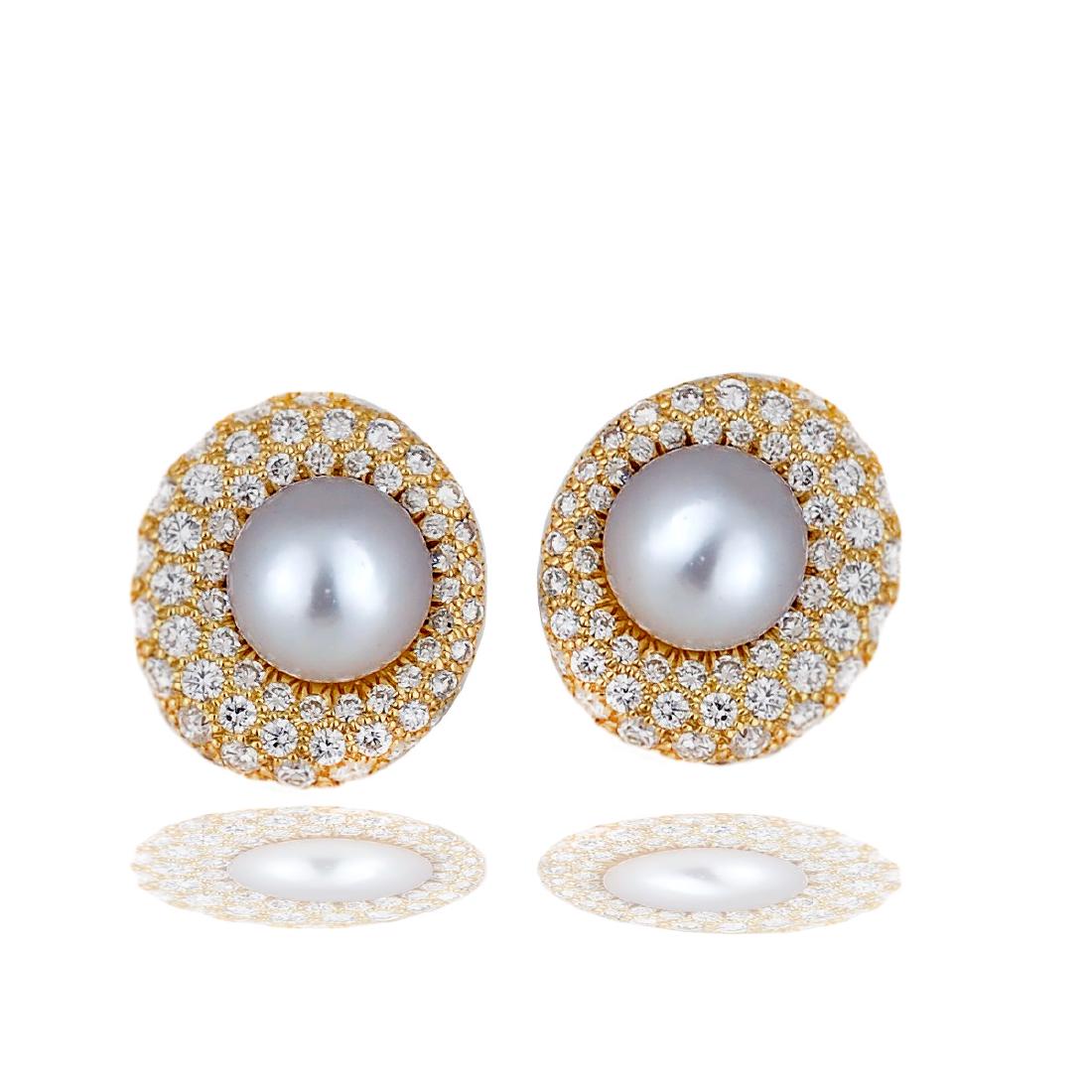 South Sea, 11.30 mm Pearl and 3.50 Carat Diamonds Set: South Sea, 11.30 mm Pearl and 3.50 Carat Diamonds Set with Omegas, 14k Yellow Gold Earrings Large South Sea pearls are asymmetrically set on a background of pave set round brilliant diamonds in 14 kar
