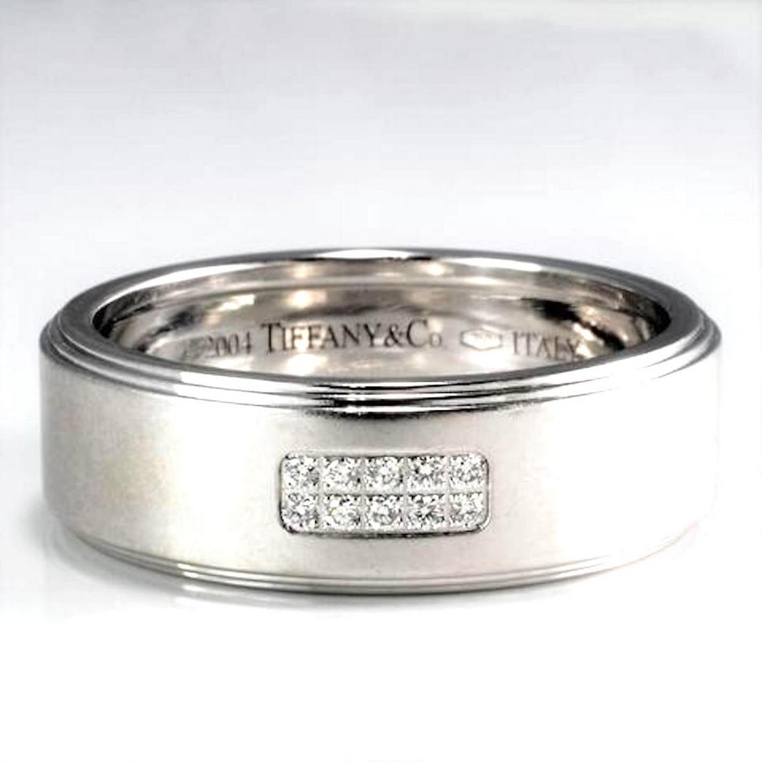 Tiffany & Co. 8mm Diamond Pave, Wedding Band: Tiffany & Co. 8mm Diamond Pave, Wedding Band 10 diamond stones, pave set in center.18K white gold Natural Diamonds (10) Carat Weight: 0.10 Cut: Round Brilliant Color: H Clarity: VS1 Ring Size:10.5. 8 