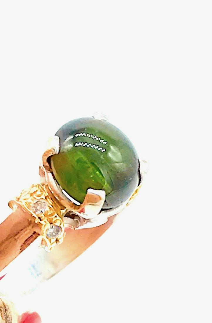 Russian 2 CT Cats Eye Diopside and Diamond Ring, 14: Russian Cats Eye Diopside and Diamond Ring, 14 Karat Oval shaped gemstone, shows off in sunlight with a strong Cat's Eye line traveling lengthwise as it travels with movement. 7.10 x 7 x 5.50 gemstone
