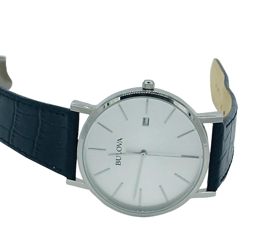 Gents, Bulova Watch, Quartz White 35 mm Face: Bulova Watch, Quartz White 35 mm FaceLike new condition with day calendar at 3:00. Strap in great condition. Silver case. Comes with Fresh Battery. 9 inches total length.GIA Gemologist inspected and e