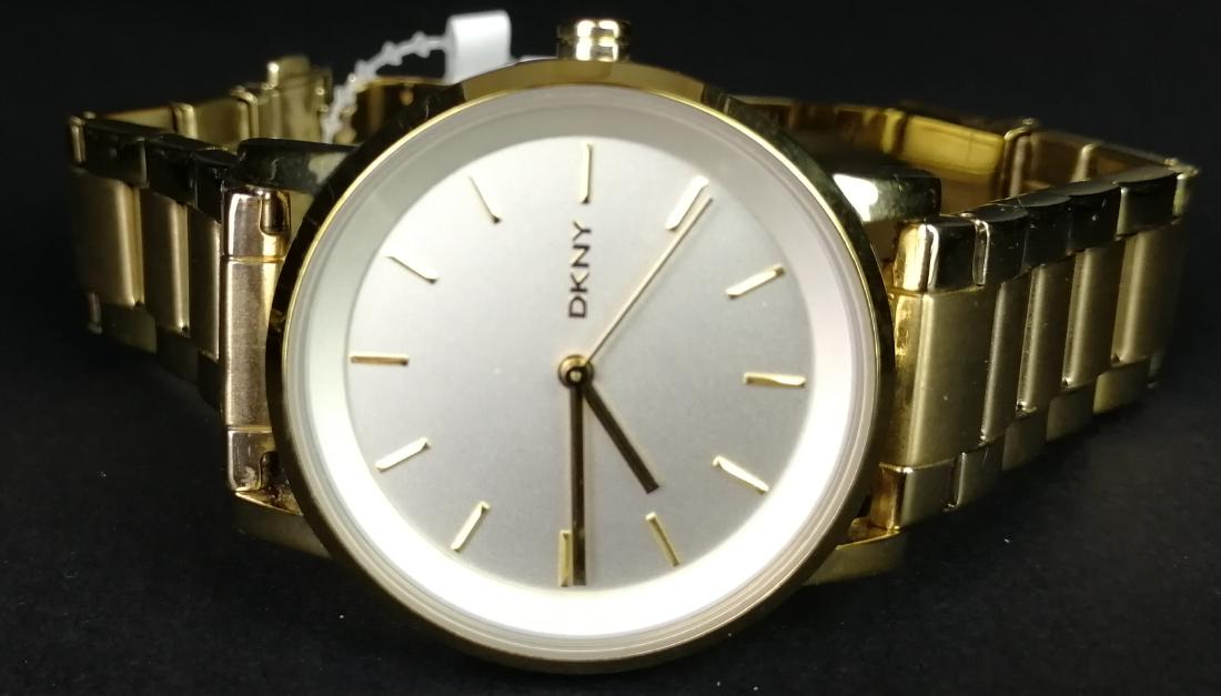 LADIES' DKNY QUARTZ WRISTWATCH, ref NY-2343, 34mm: LADIES' DKNY QUARTZ WRISTWATCH, ref NY-2343, 34mm circular gold plated case, round off-white dial, bracelet, currently not running - may require a new battery.
