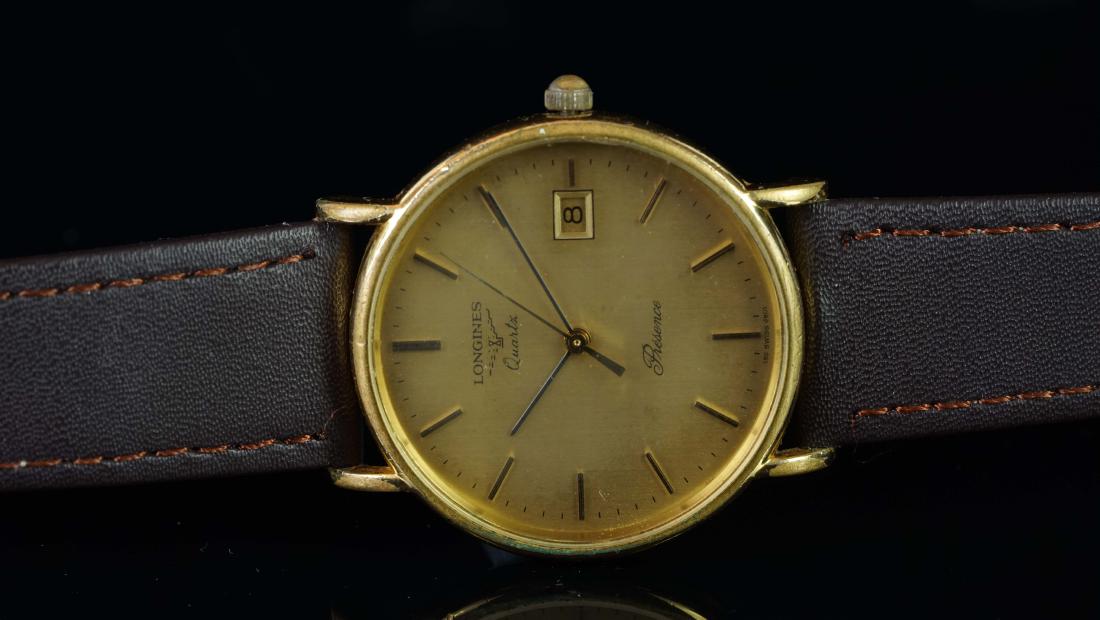 GENTLEMEN'S LONGINES PRESENCE, DRESS WATCH, QUARTZ: GENTLEMEN'S LONGINES PRESENCE, DRESS WATCH, QUARTZ WRISTWATCH, circular gold tone dial with black sword hands, central gold tone second hand, date at 3o'clock, applied indices with minute track on the