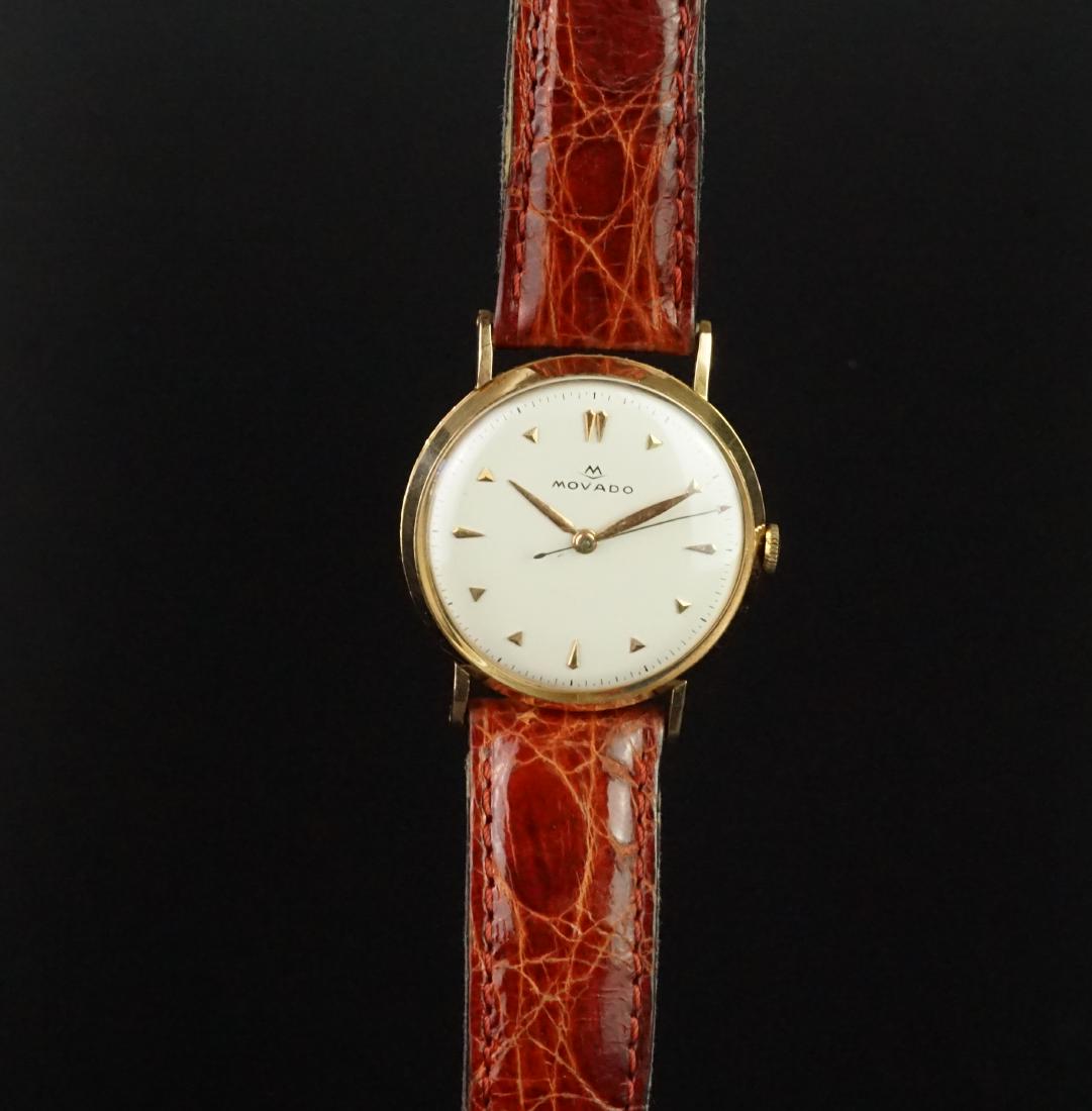 GENTLEMEN'S MOVADO VINTAGE 18K ROSE GOLD DRESS WATCH,: GENTLEMEN'S MOVADO VINTAGE 18K ROSE GOLD DRESS WATCH, circular off white dial with triangular faceted hour markers and gold hands, long thin arrow second hand, smooth bezel and thin lugs on a 33mm 18k