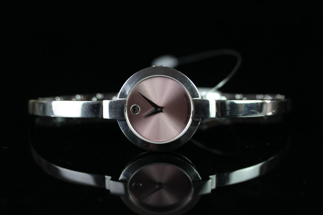 LADIES' MOVADO BANGLE WRISTWATCH, circular pink brushed: LADIES' MOVADO BANGLE WRISTWATCH, circular pink brushed dial with silver marker indicating 12, silver dauphine hands, 24mm stainless steel case with crown, on an integrated bracelet, watch is currentl