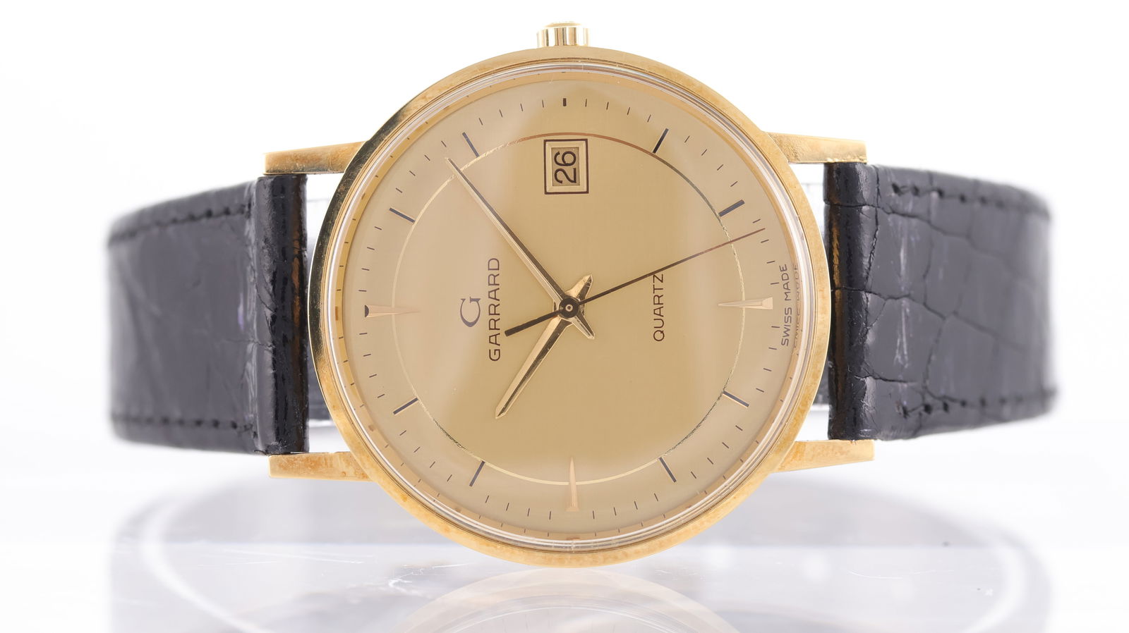 Garrard by Zenith 18ct yellow gold Date Quartz Circa 1990's: Brand: Garrard Model Name: by Zenith Reference: 30.1740.116 Movement: Quartz Year: Circa 1990's Dial shape: Circular Dial colour: Champagne Dial features: Baton hour markers, quickset date aperture at
