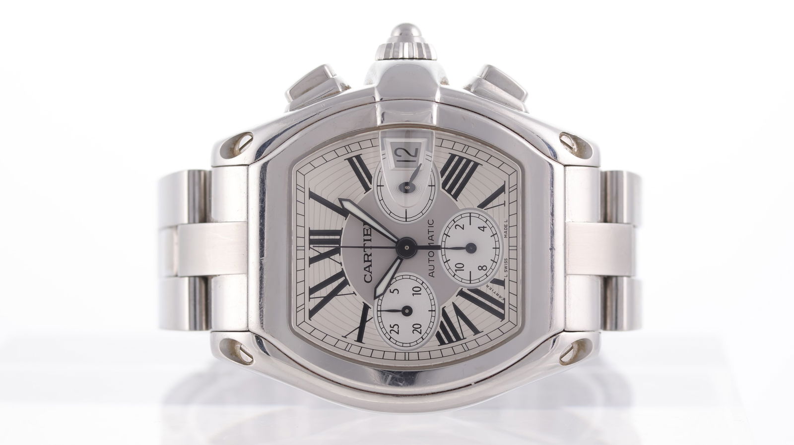 Cartier Roadster Chronograph Automatic Ref 2618: Brand: Cartier Model Name: Roadster Reference: 2618 Movement type: Automatic Dial shape: Tonneau Dial colour: White Dial features: Black roman numeral hour markers. quickset aperture at 3 o'clock, thr