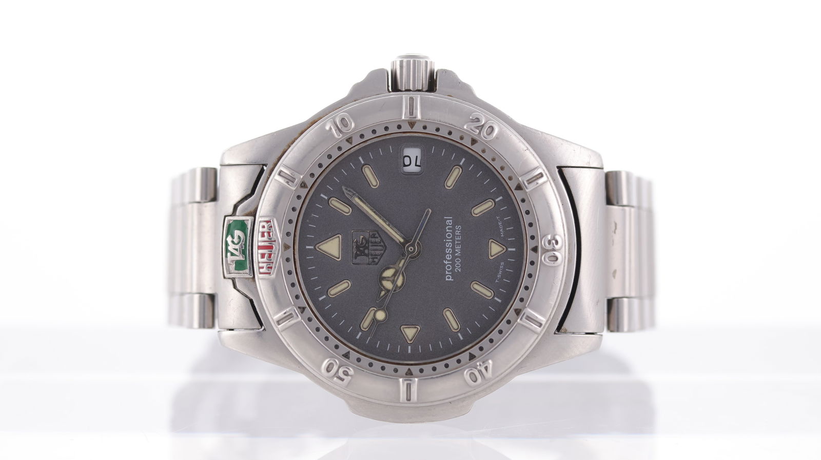 Tag Heuer Professional Ref WF1211-K0: Brand: Tag Heuer Model Name: Professional Reference: WF1211-K0 Movement type: Quartz Dial shape: Circular Dial colour: Grey Dial features: Silver/lume hands and hour markers. Date aperture at 3 o'cloc