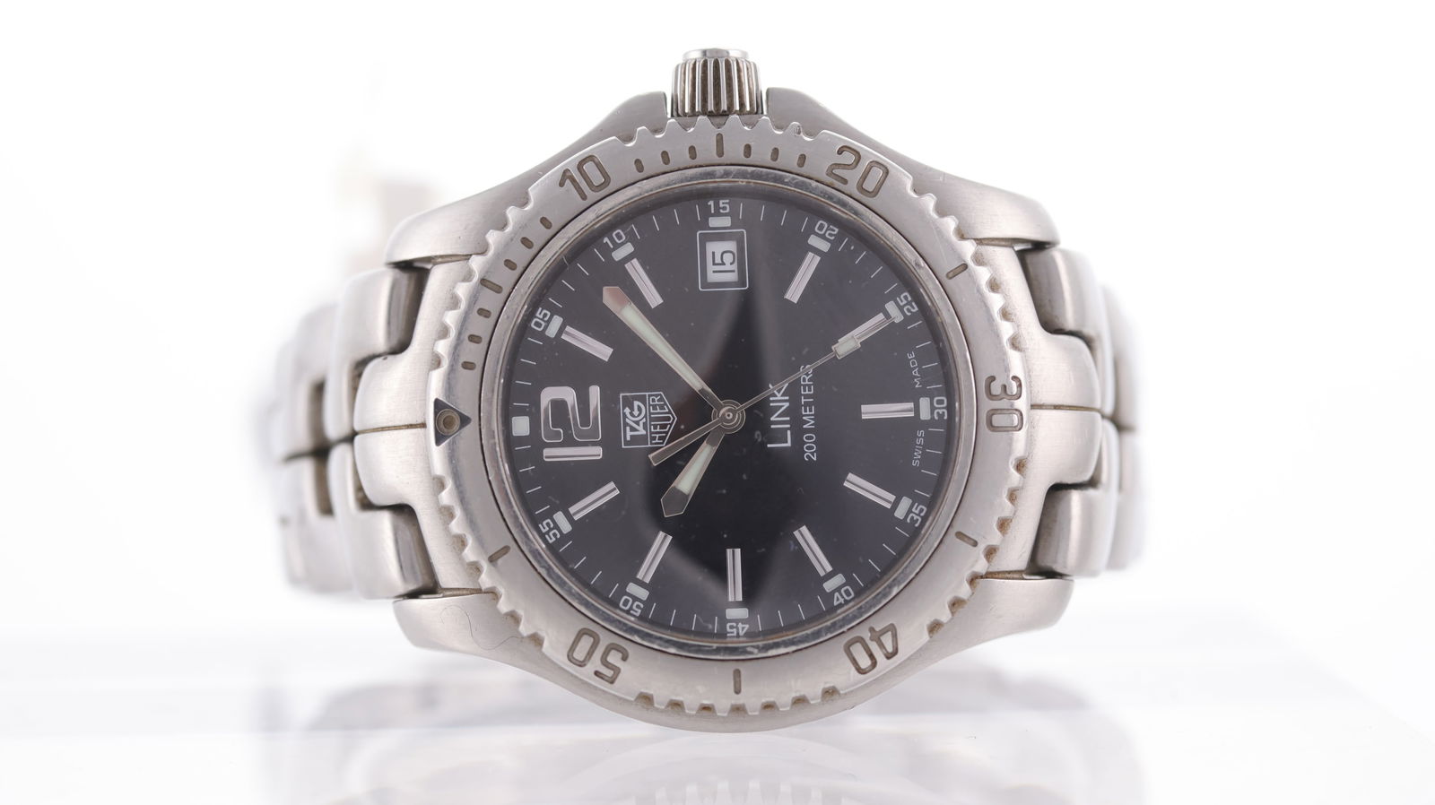 Tag Heuer Link Date Ref WT1110-0 with Box and Papers 2007: Brand: Tag Heuer Model Name: Link Reference: WT1110-0 Movement type: Quartz Year: 2007 Box: Full Box Papers: Full Set Papers Dial shape: Circular Dial colour: Black Dial features: Applied baton hour m