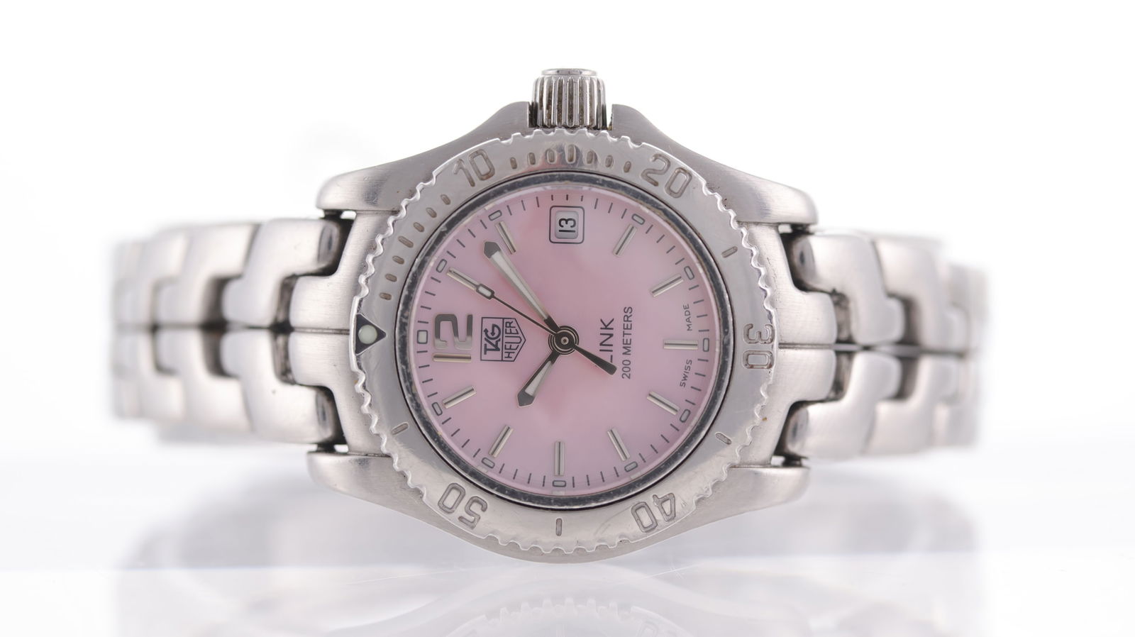 Tag Heuer Link Ref WT141M Circa 2000: Brand: Tag Heuer Model Name: Link Reference: WT141M Movement type: Quartz Year: Circa 2000 Dial shape: Circular Dial colour: Pink Dial features: baton hour markers, date aperture at 3 o'clock Bezel: U