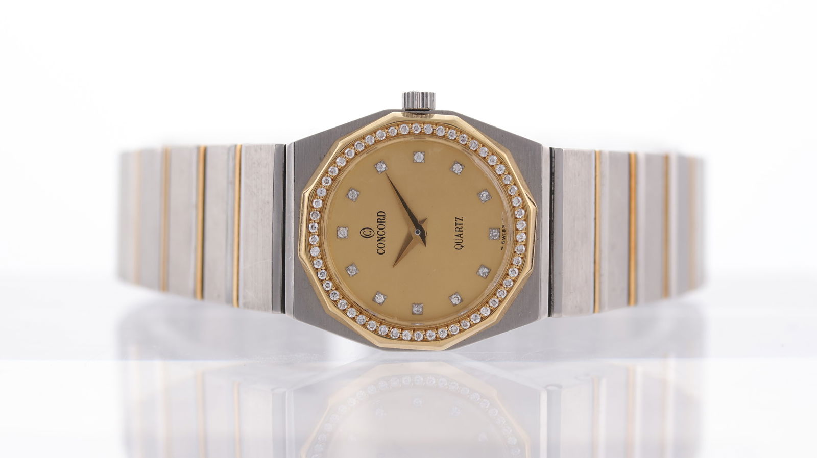 Concord Mariner Steel and Gold Diamond Set Circa 1970's: Brand: Concord Model Name: Mariner Movement type: Quartz Dial shape: Circular Dial colour: Champagne Dial features: Diamond dot hour markers Bezel: Gold diamond set bezel Case size: 23mm Case material