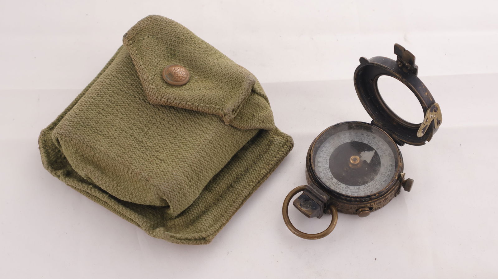 Vintage WWII British Military Compass and Pouch Circa 1940's: Vintage WWII British Military Compass and Pouch Circa 1940's, features the military broad arrow to the case back