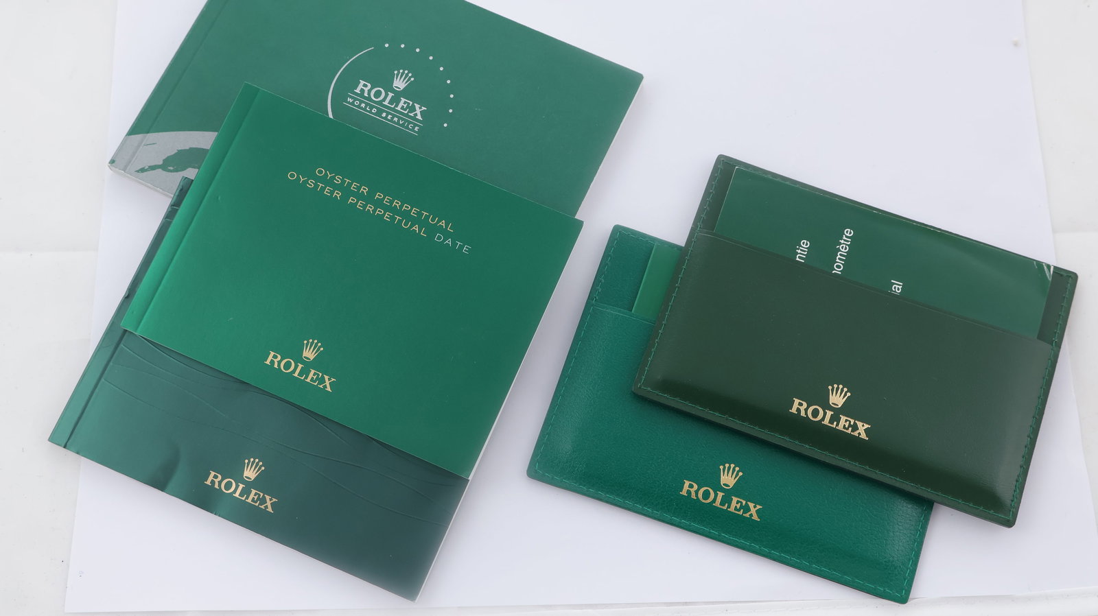 Rolex Watch Booklets: 1 x Rolex service booklet, 2 x Service manuals, 2 leather warranty card holders. 1 GMT Master II instructions, 1 Oyster Perpetual Date instructions