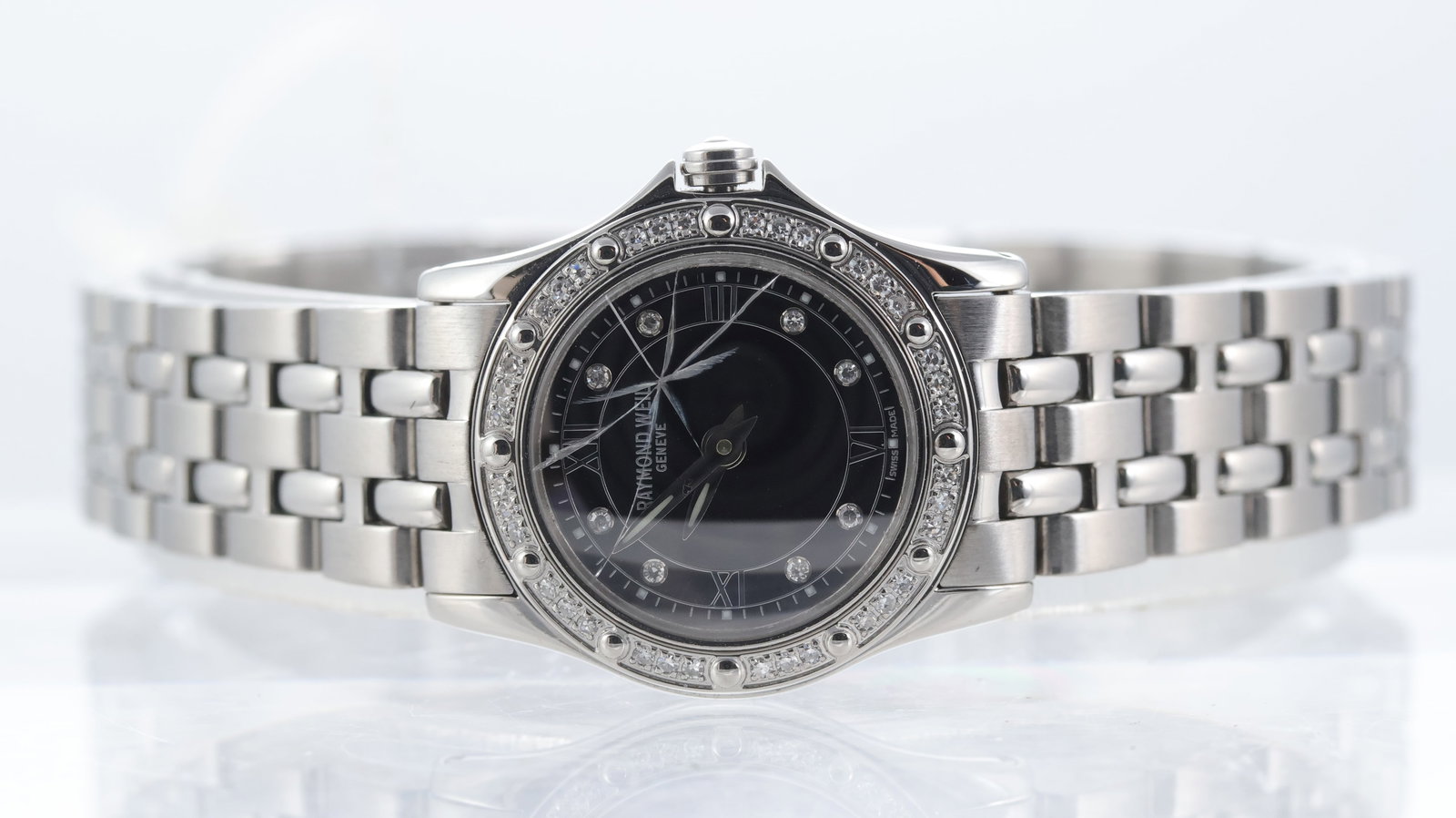 ladies Raymond Weil Tango Quartz Ref 5790: Brand: Raymond Weil Model Name: Tango Reference: 5790 Movement type: Quartz Dial shape: Circular Dial colour: Black Dial features: Dot stone hour markers. Roman numeral quarters. Bezel: Stone set
