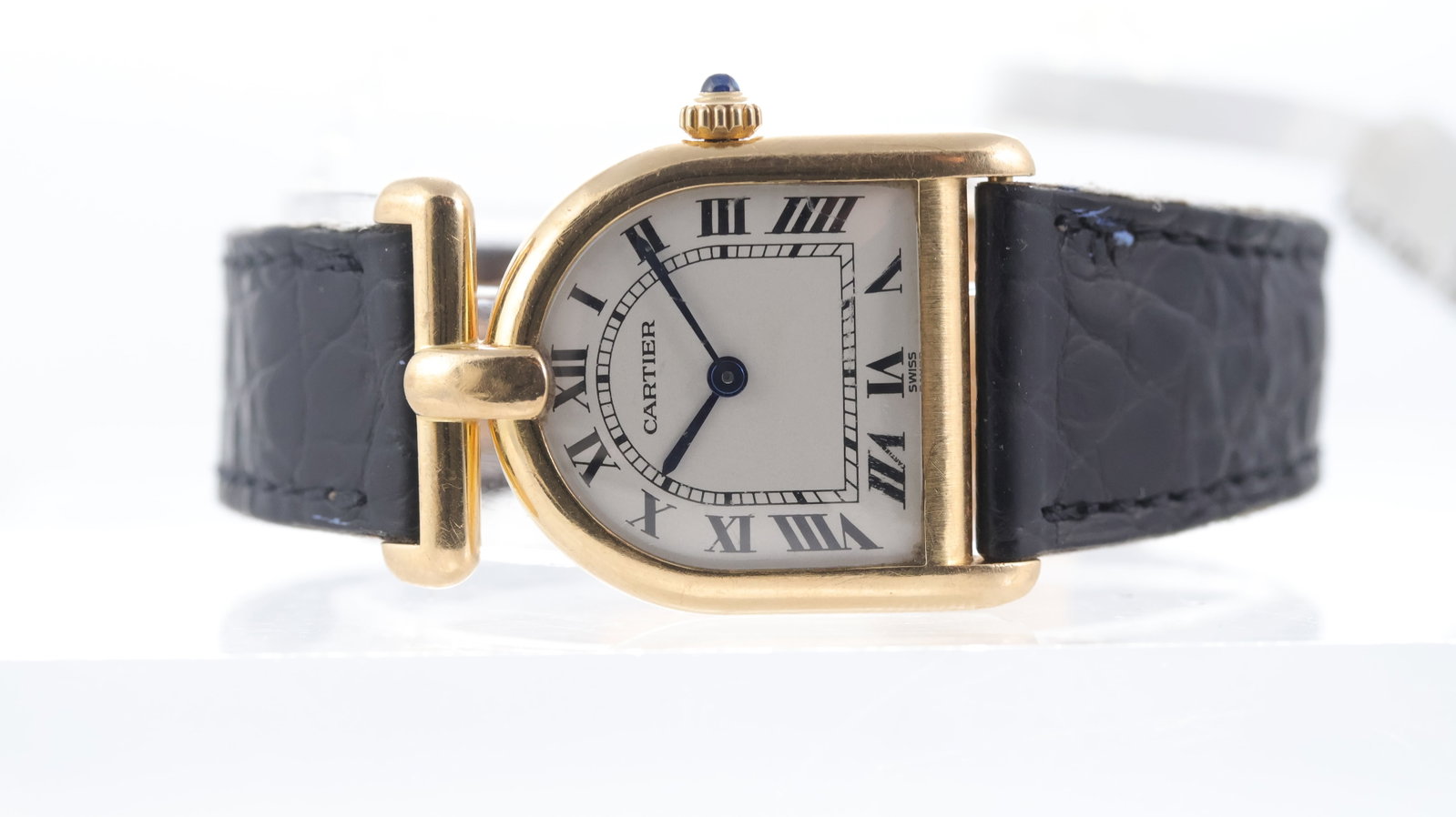 Rare Cartier Cloche Calandre 18ct yellow gold Ref 8108 Circa 1980s: Brand: Cartier Model Name: Cloche Calandre Reference: 8108 Movement type: Quartz Year: Circa 1980s Dial shape: Tunnel Dial colour: White Dial features: Black roman numeral hour markers, blue hands, 's