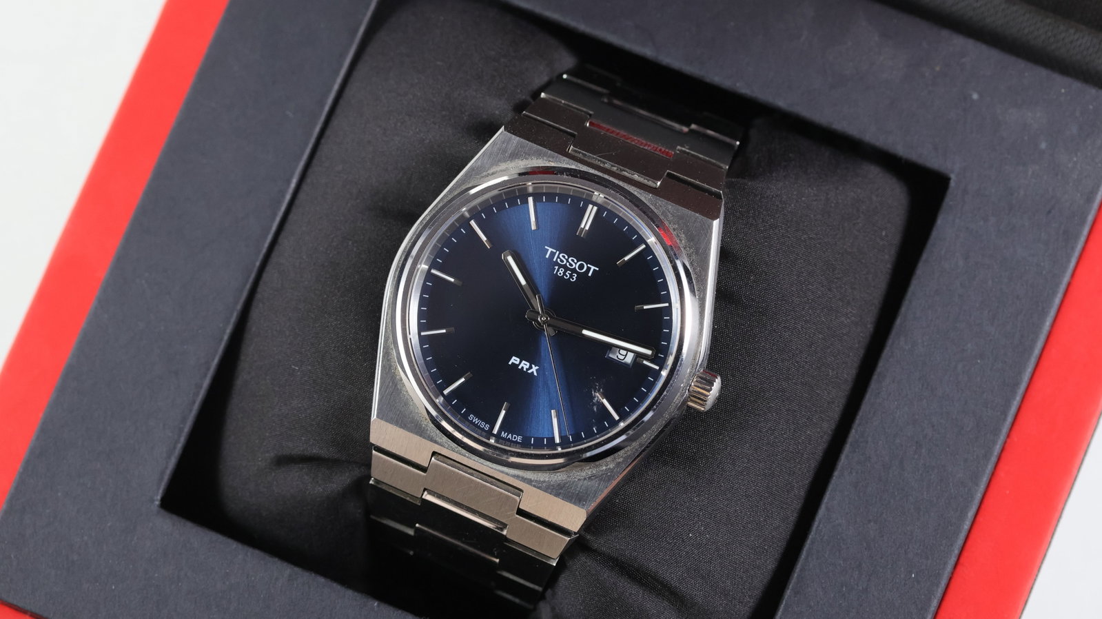 Tissot Prx Quartz Ref T137410A with Box: Brand: Tissot Model Name: Prx Reference: T137410A Movement type: Quartz Box: Full Box Dial shape: Circular Dial colour: Sunburst, Blue Dial features: Silver baton hour markers. Date aperture at 3 o'cl