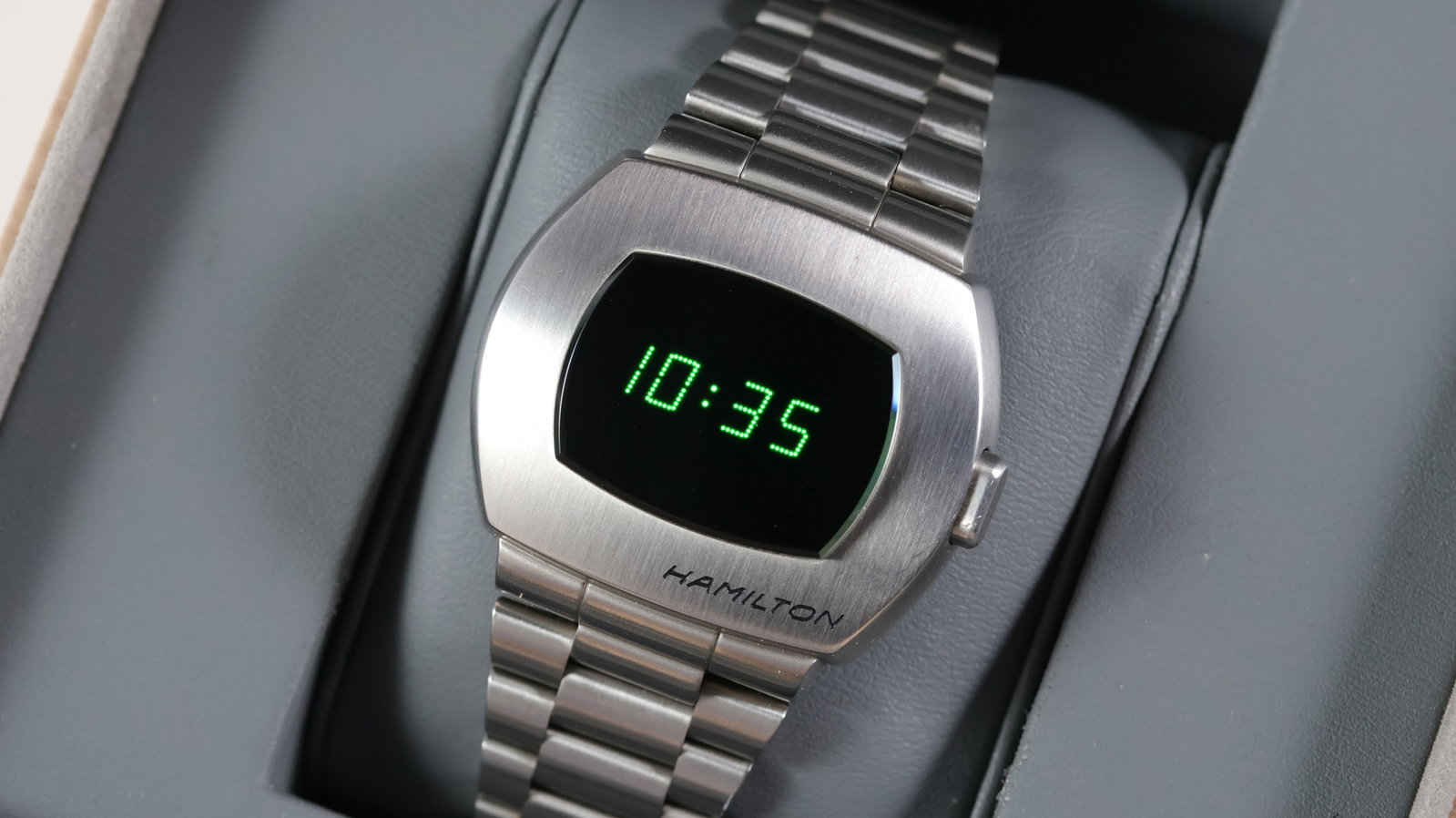Hamilton PSR Ref H524140 with Box: Brand: Hamilton Model Name: PSR Reference: H524140 Movement type: Quartz Box: Full Box Dial shape: Cushion Dial colour: Black Dial features: Digital screen with green text. Case size: 40.5mm Case mate