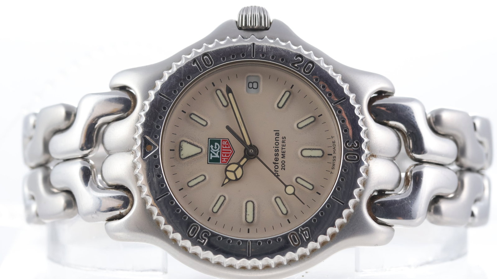 Tag Heuer SEL Series Ref S99.006M/E Circa 1990s: Brand: Tag Heuer Model Name: SEL Series Reference: S99.006M/E Movement type: Quartz Year: Circa 1990s Dial shape: Circular Dial colour: Cream Dial features: Patina dial, Tritium mercedes hands and hou