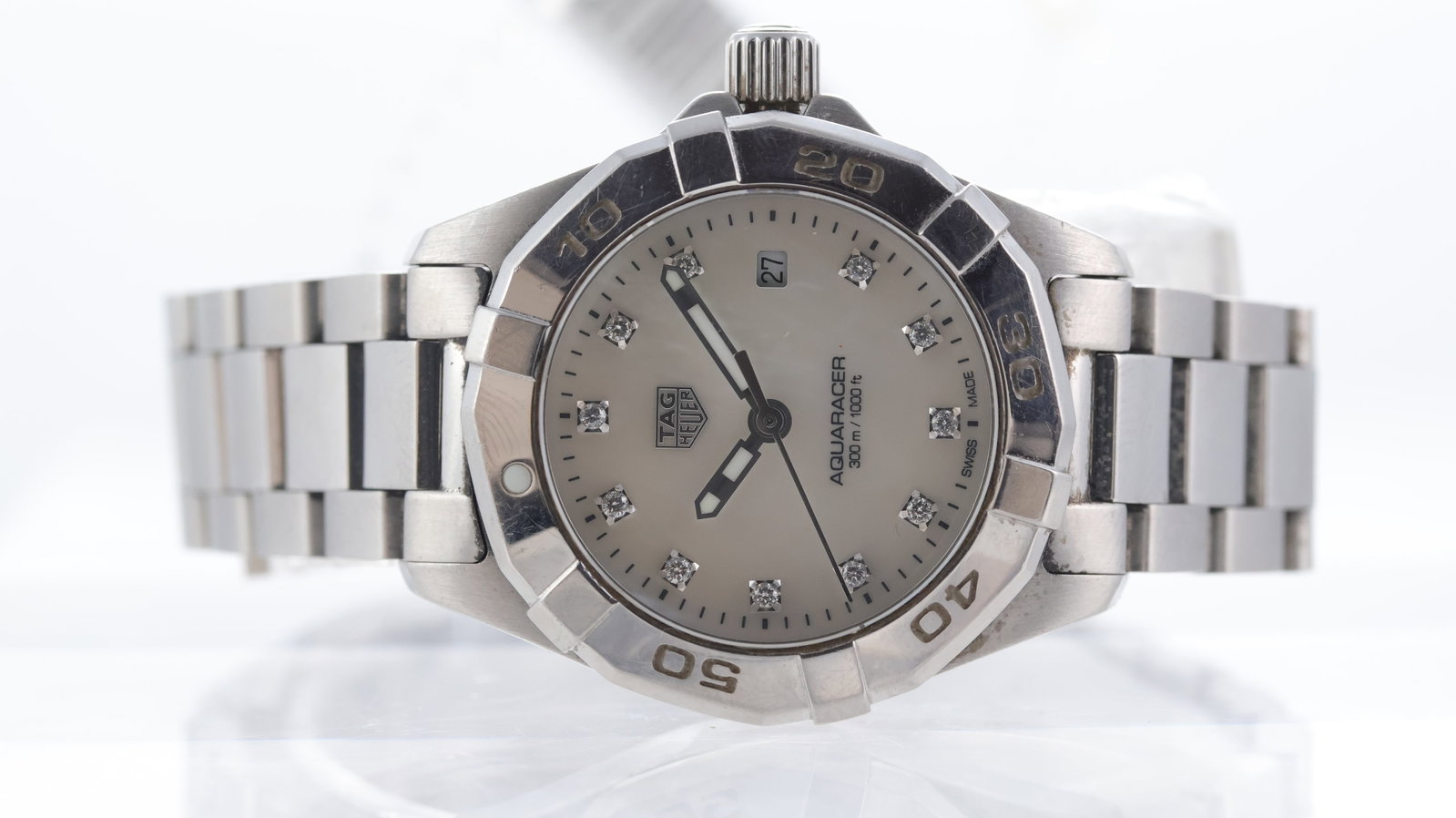 Tag Heuer Aquaracer Ref WBD1414 with Papers: Brand: Tag Heuer Model Name: Aquaracer Reference: WBD1414 Movement type: Quartz Papers: Guarantee Card Papers features: 2x modern Tag Heuer cards warranty and diamond Dial shape: Circular Dial colour: