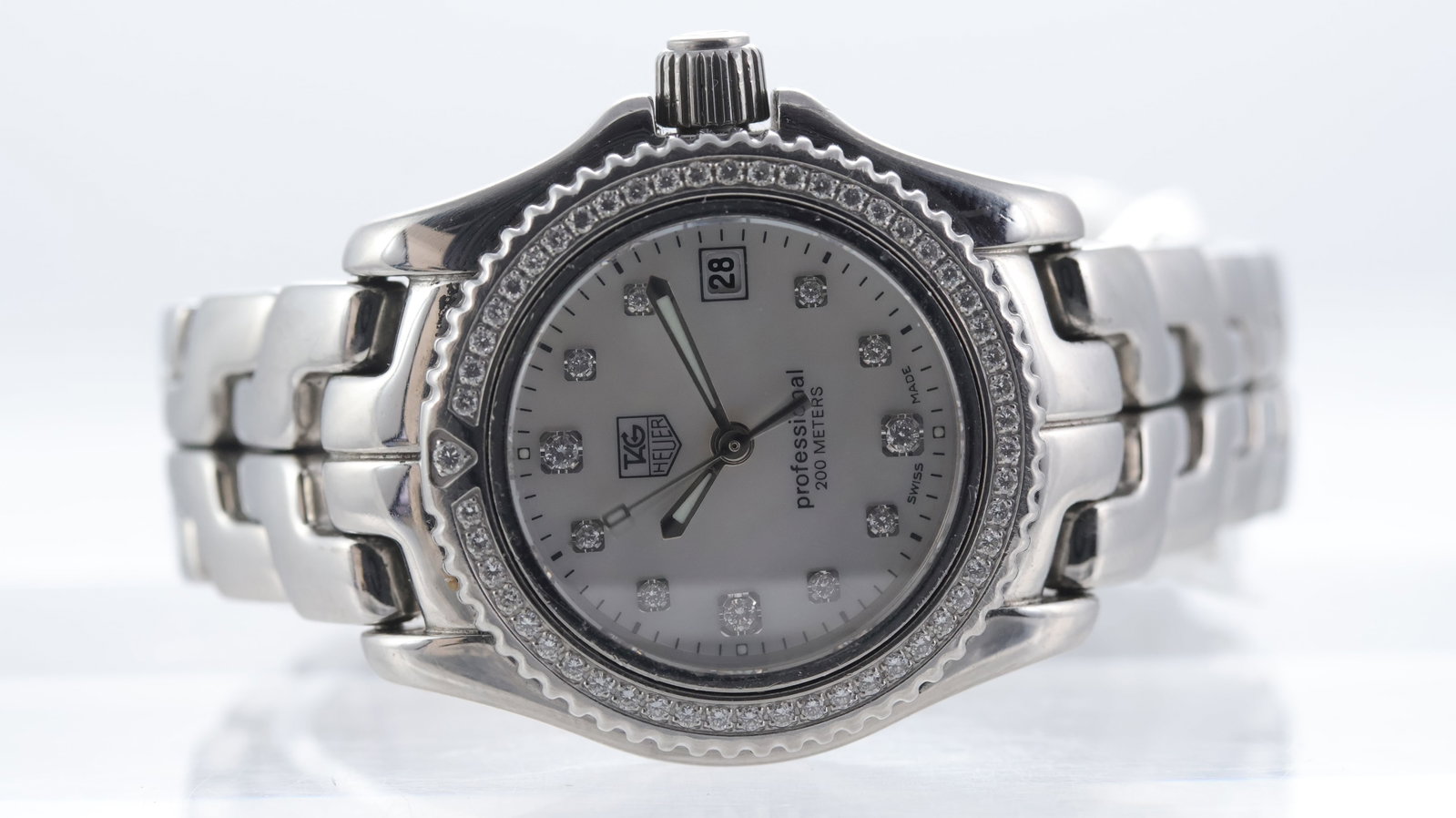 Tag Heuer Link Ref WT141J: Brand: Tag Heuer Model Name: Link Reference: WT141J Movement type: Quartz Dial shape: Circular Dial colour: Mother of pearl Dial features: Diamond hour markers, date aperture at 3 o'clock Bezel: