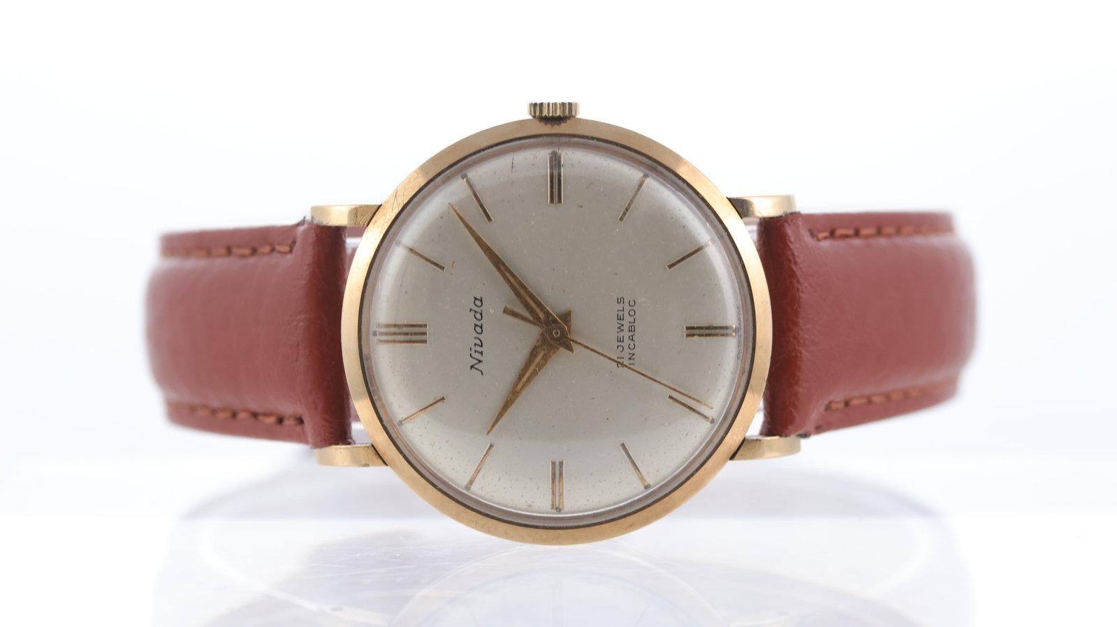 Nivada Vintage 9ct Gold with Box Circa 1964: Brand: Nivada Model Name: Vintage Movement type: Manual Wind Year: Circa 1964 Box: Accompanying Box Dial shape: Circular Dial colour: Silver Dial features: Baton hour markers Bezel: Smooth Case size: 