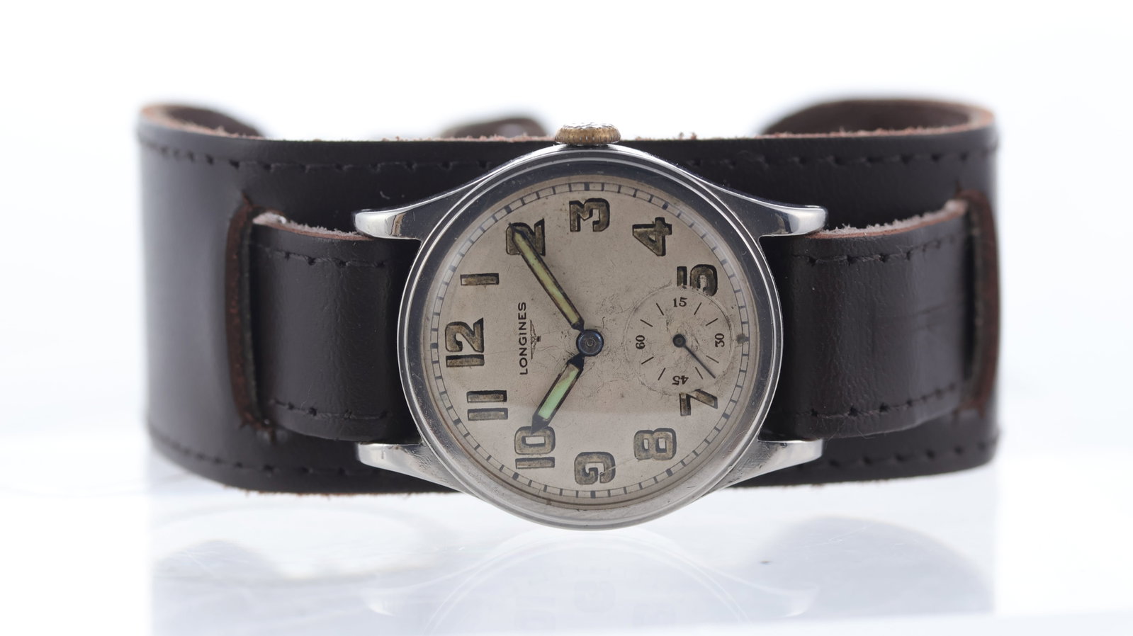 Vintage Longines Officer Style Mechanical Watch Circa 1939: Brand: Longines Model Name: Vintage Movement type: Manual Wind Movement features: Longines signed movement Year: Circa 1939 Dial shape: Circular Dial colour: White Dial features: Patina dial with arab