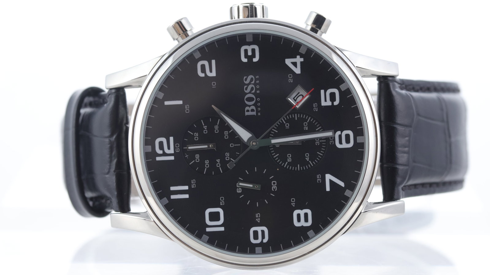 Hugo Boss Chronograph: Brand: Hugo Boss Model Name: Chronograph Movement type: Quartz Dial shape: Circular Dial colour: Black Dial features: Arabic numerals, subsidiary dials, date aperture at 4:30 Bezel: Smooth Case size: