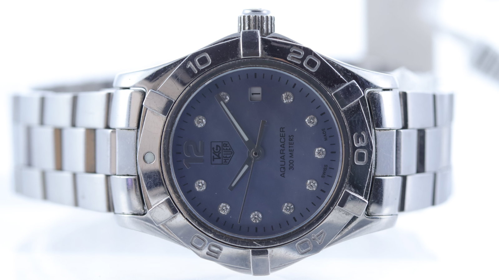Ladies Tag Heuer Aquaracer Quartz Ref WAF1419: Brand: Tag Heuer Model Name: Aquaracer Reference: WAF1419 Movement type: Quartz Dial shape: Circular Dial colour: Mother of Pearl Dial features: Stone set hour markers. Date aperture at 3 o'clock. Bez