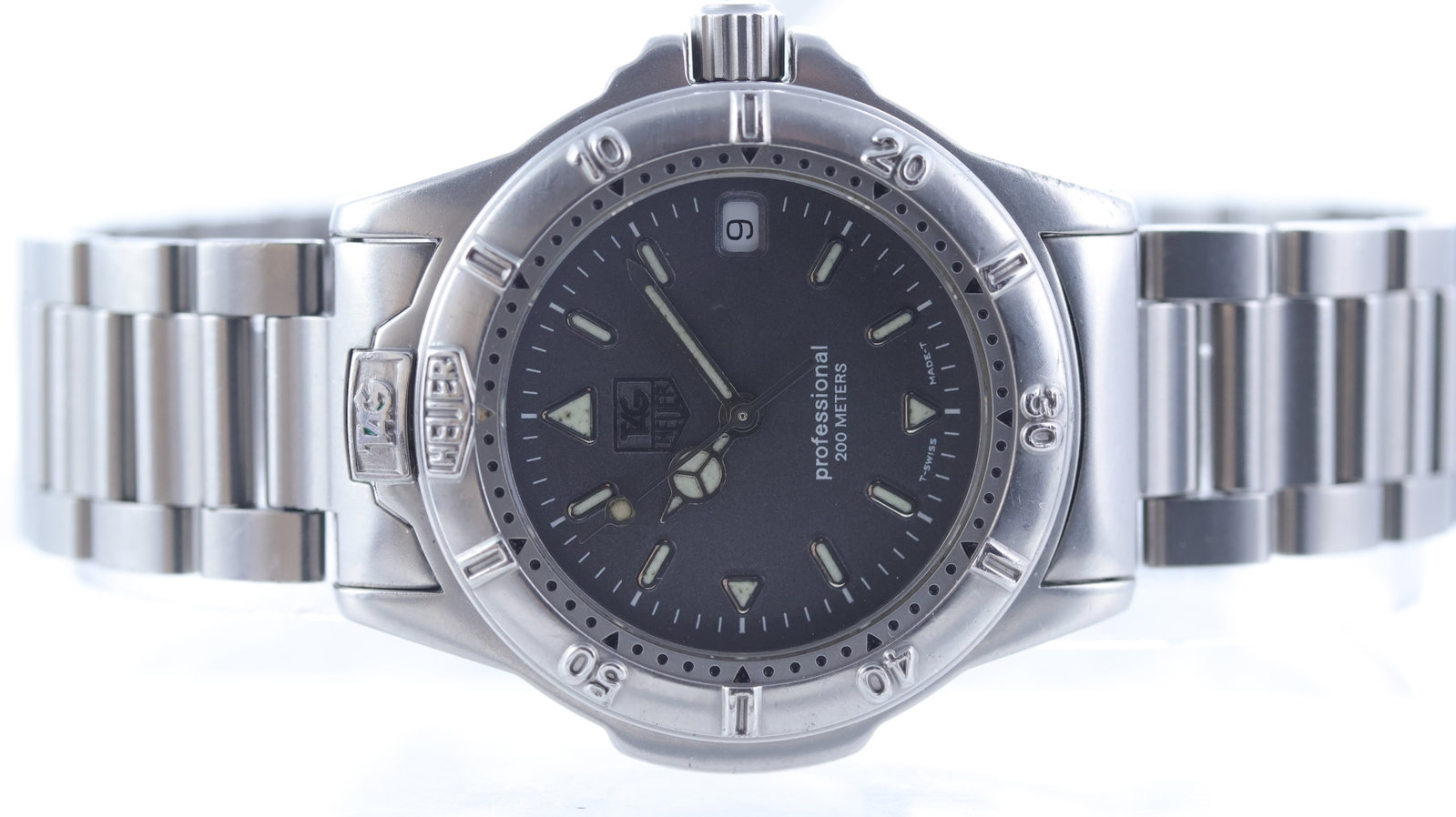 Tag Heuer Professional Quartz Date Ref WF1211-K0: Brand: Tag Heuer Model Name: Professional Reference: WF1211-K0 Movement type: Quartz Dial shape: Circular Dial colour: Grey Dial features: Tritium mercedes hands and rounded hour markers. Date apertur