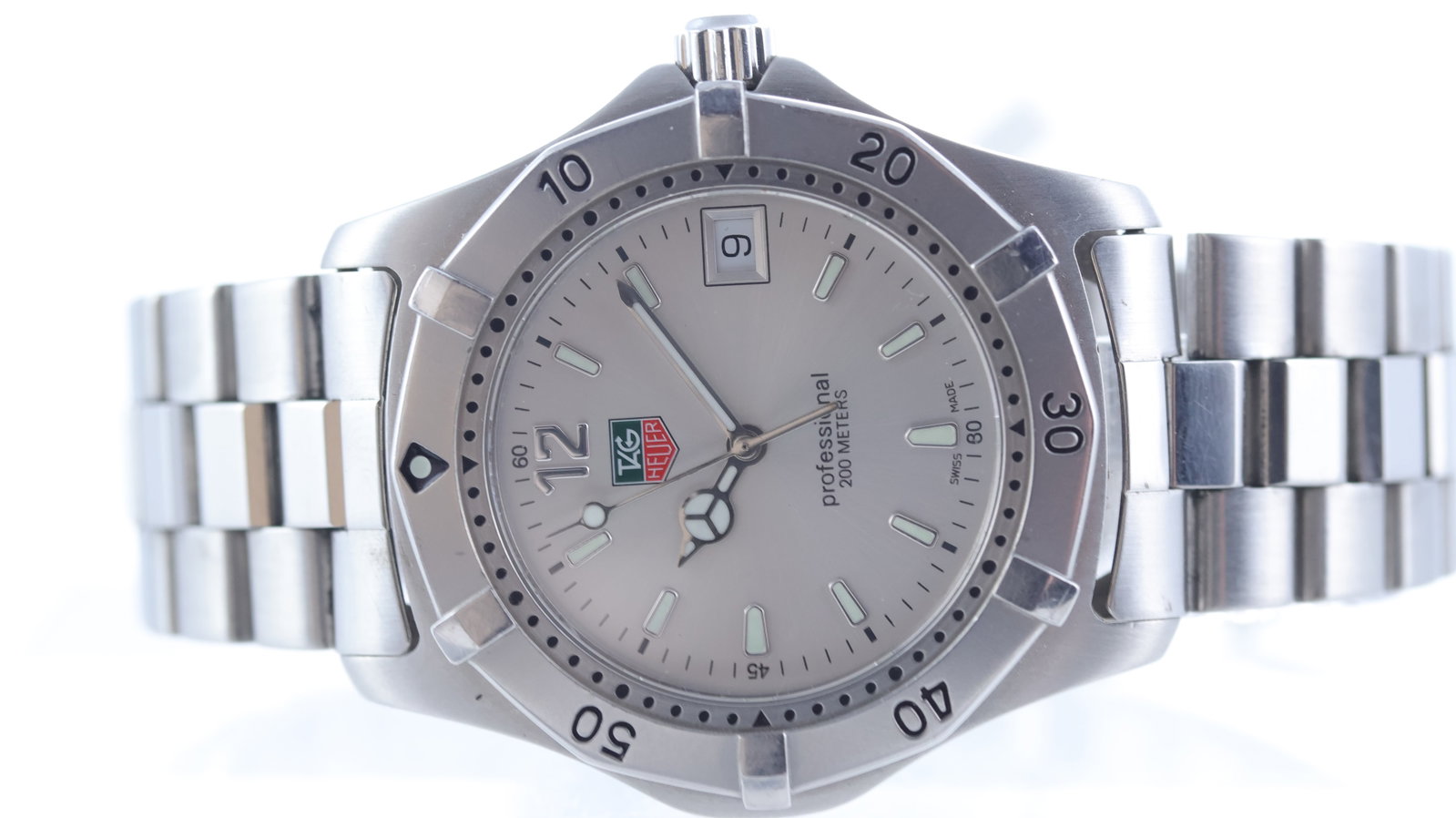 Tag Heuer Professional 2000 Ref WK1112-0: Brand: Tag Heuer Model Name: Professional 2000 Reference: WK1112-0 Movement type: Quartz Dial shape: Circular Dial colour: Sunburst silver Dial features: Mercedes handset. Rounded hour markers. Date a