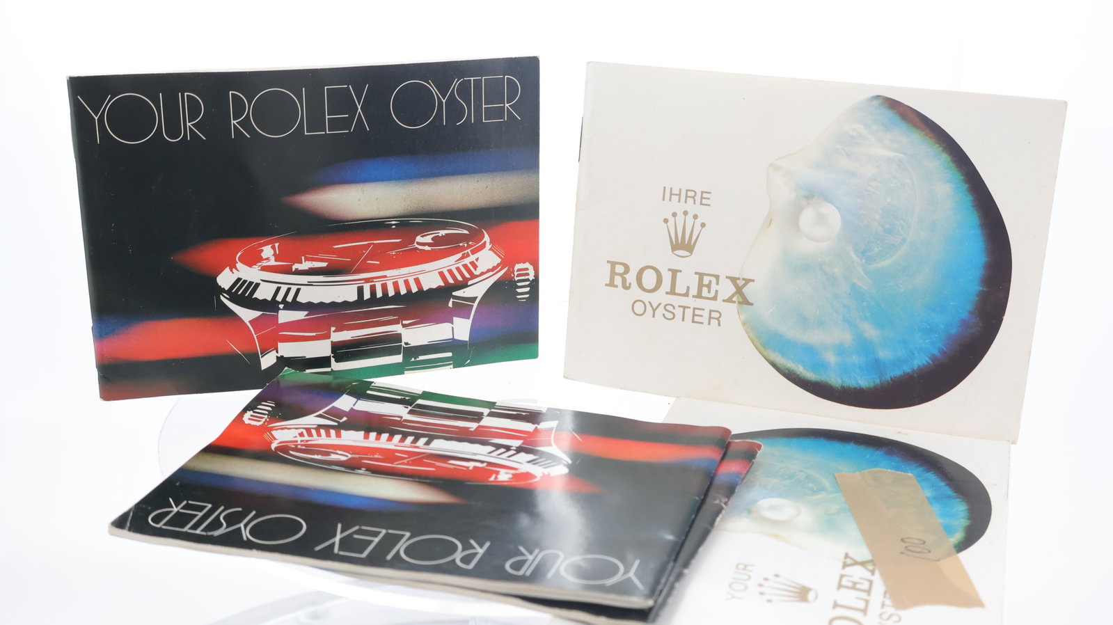 Rolex Oyster Booklets, 2x shell fronted white booklets 579.07 / 579.08 and 3x Black fronted Circa: Rolex Oyster Booklets, 2x shell fronted white booklets 579.07 / 579.08 and 3x Black fronted Circa 1982, 579.22 / 100.3.80